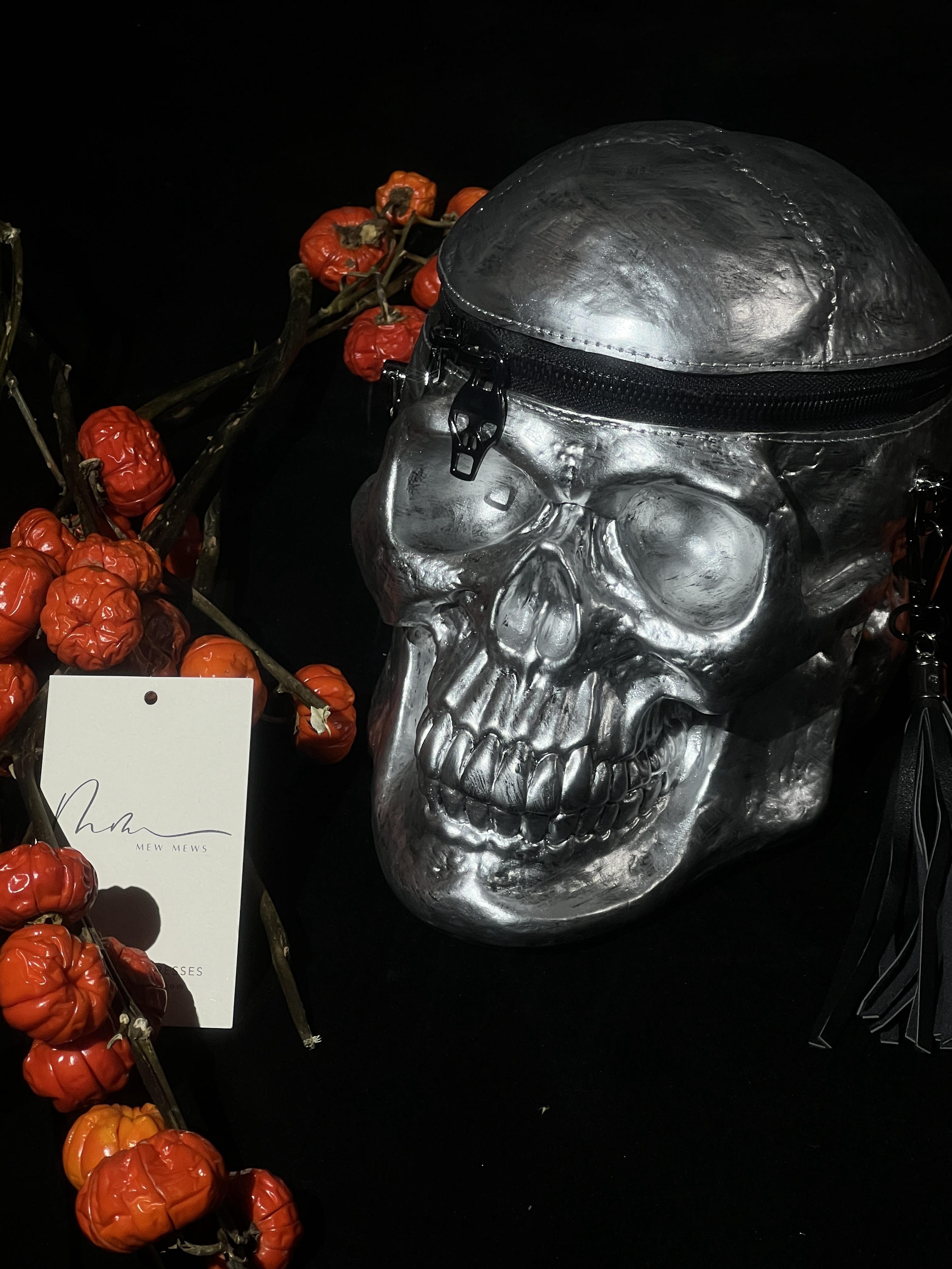 Alaric Silver Skull Clutch showcasing a unique skull design, perfect for gothic fashion and Halloween parties.