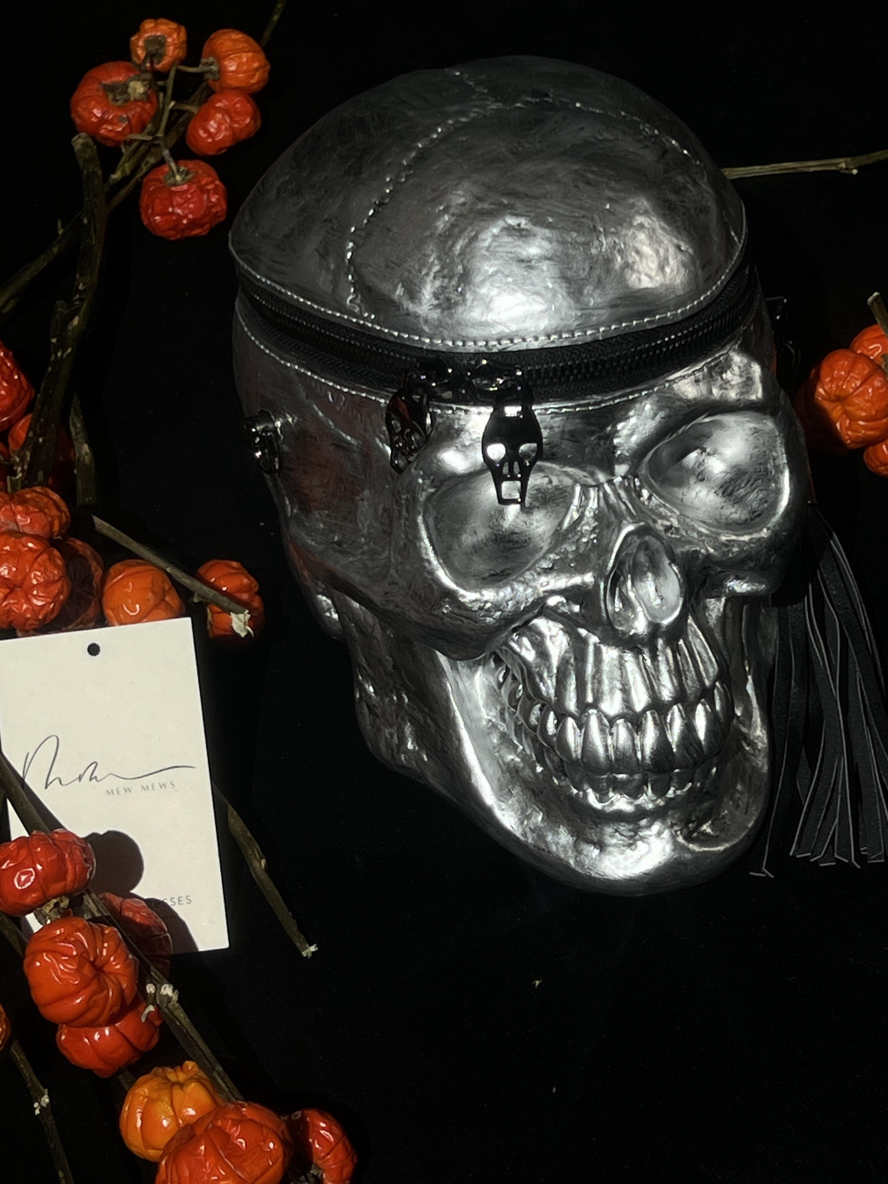 Alaric Silver Skull Clutch showcasing a unique skull design, perfect for gothic fashion and Halloween parties.