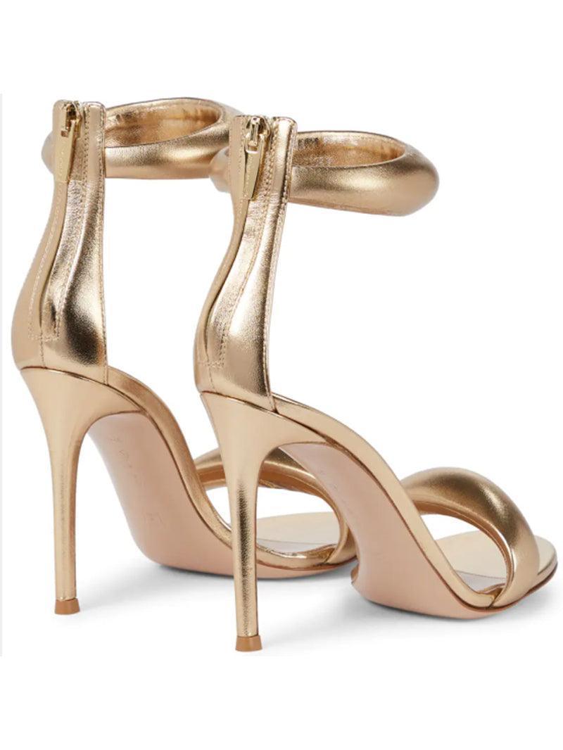 Aleena Gold Ankle Strap Sandals, a stylish pair perfect for evening wear with a shimmery finish and comfortable heels.