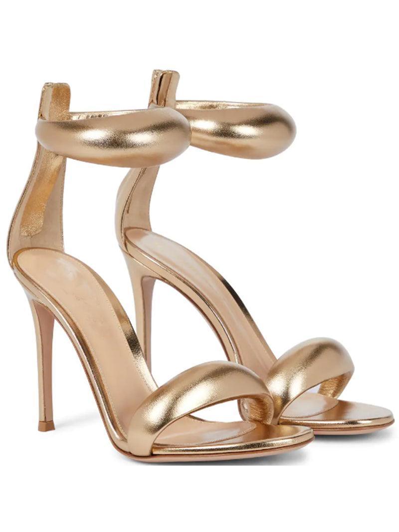 Aleena Gold Ankle Strap Sandals, a stylish pair perfect for evening wear with a shimmery finish and comfortable heels.