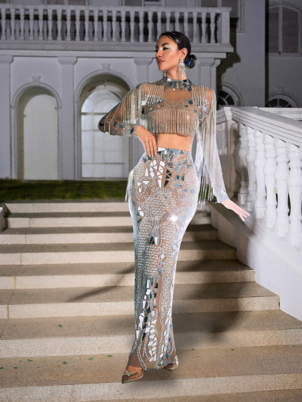 Model wearing the Alvin Acrylic Fringe Skirt Set at a vibrant party, demonstrating its movement and style.