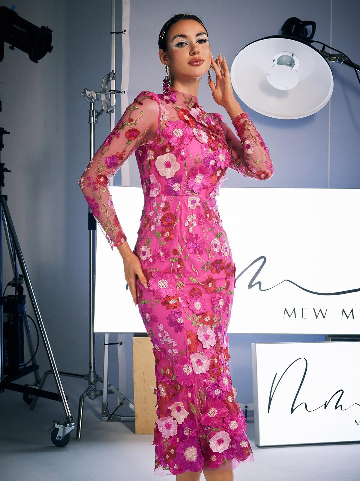 Close-up of the delicate floral embroidery on the Amara Long Sleeve Midi Dress in hot pink, highlighting its elegant design.