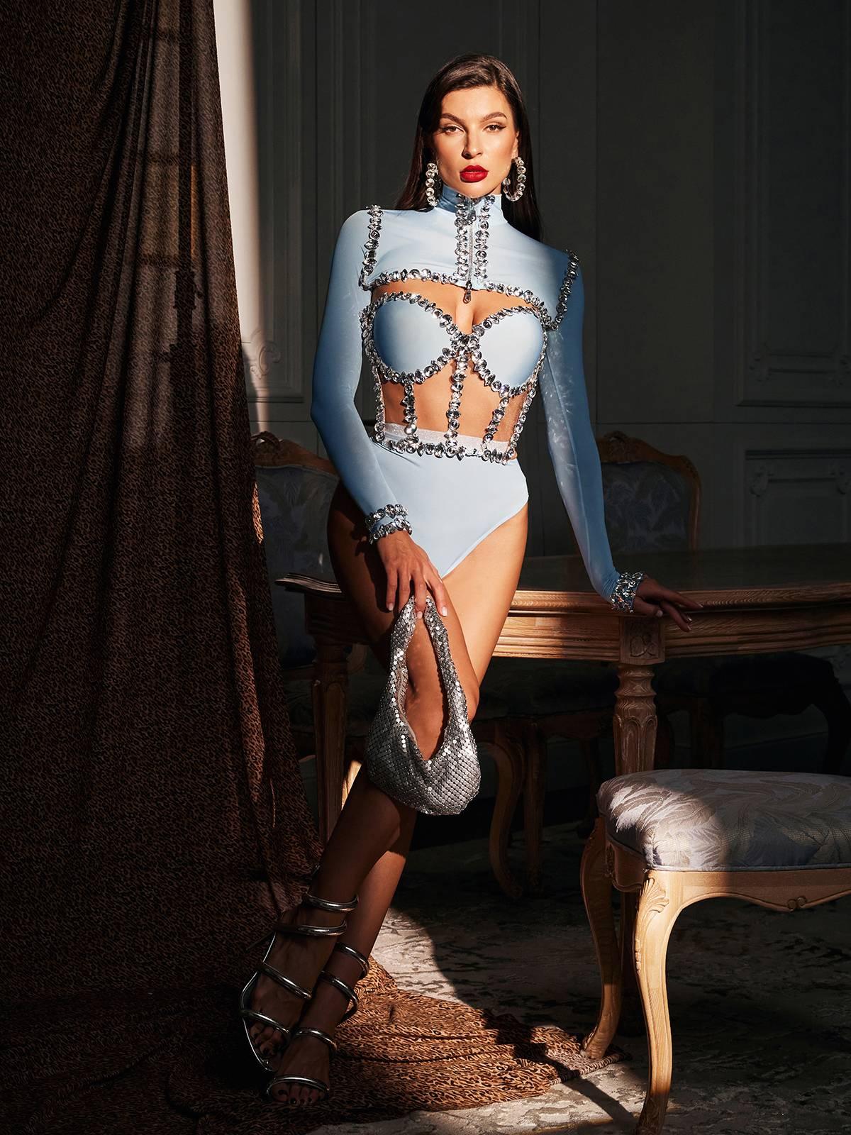 Model wearing Ambra Rhinestone Corset Bodysuit Set in Blue at a glamorous party.