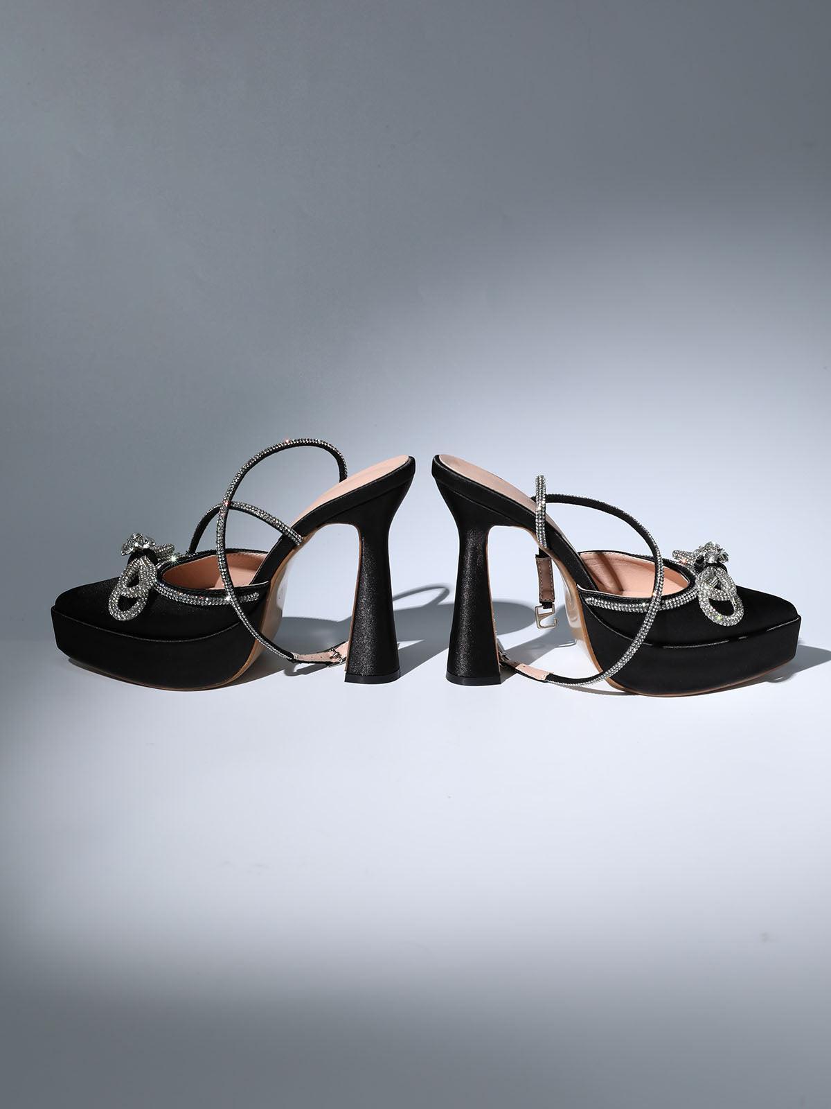 Anouk Bow Crystal Satin Heels in Black featuring elegant ankle strap and crystal embellishments.