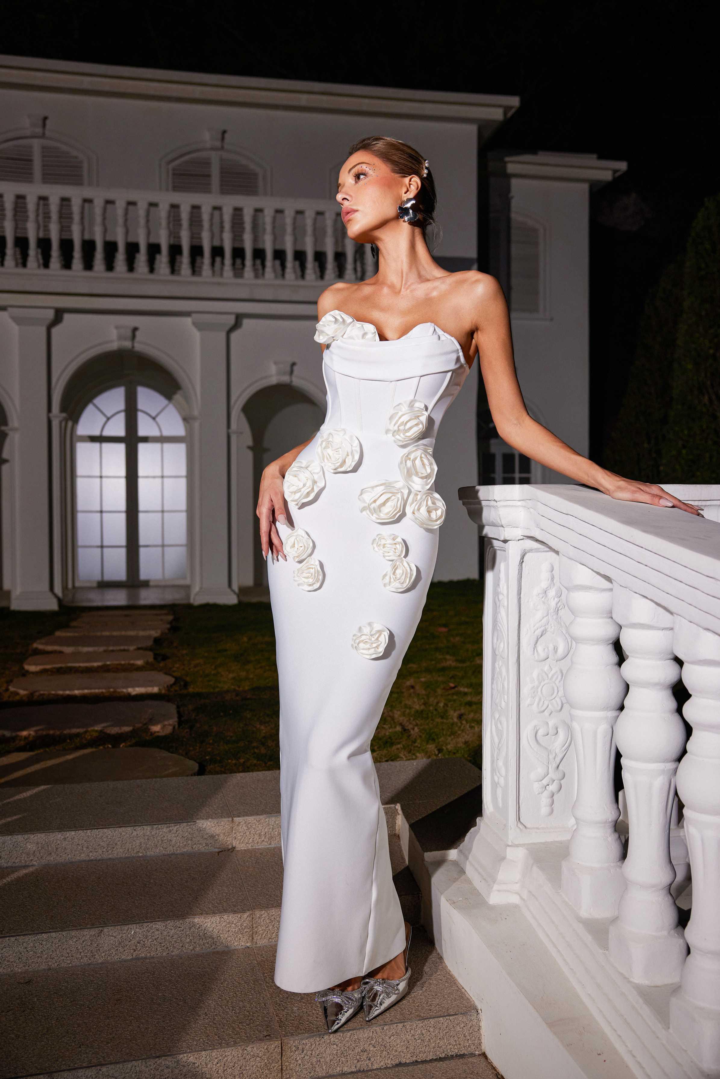 Arushi Strapless Flower Bandage Dress in white, showcasing elegant flower patterns and a curve-flattering design for evening wear.