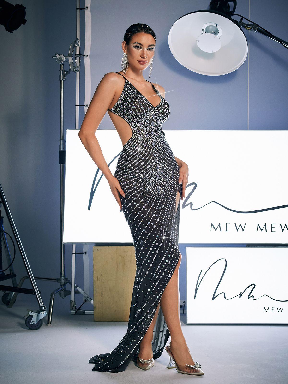 Model wearing the Aryan Backless Rhinestone Cutout Maxi Dress in black, showcasing elegant design and rhinestone embellishments.