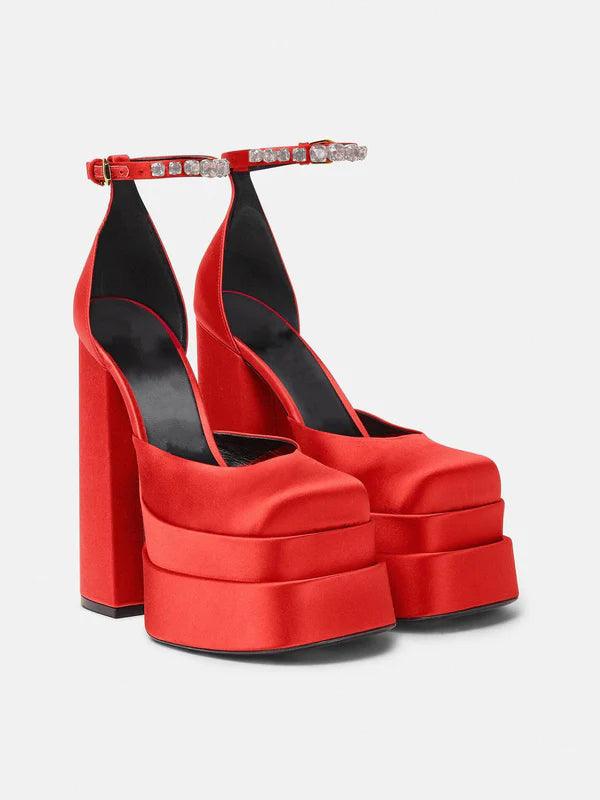 Aspen Satin Platform Pumps in a flat lay arrangement, showcasing the beautiful satin texture and elegant rhinestone accents.