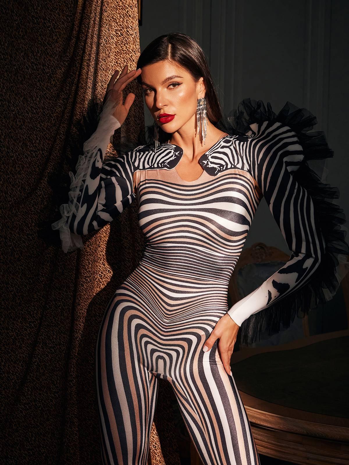 Model wearing the Assisi Tulle Trimmed Zebra Printed Jumpsuit at a festival, highlighting its bold animal print.