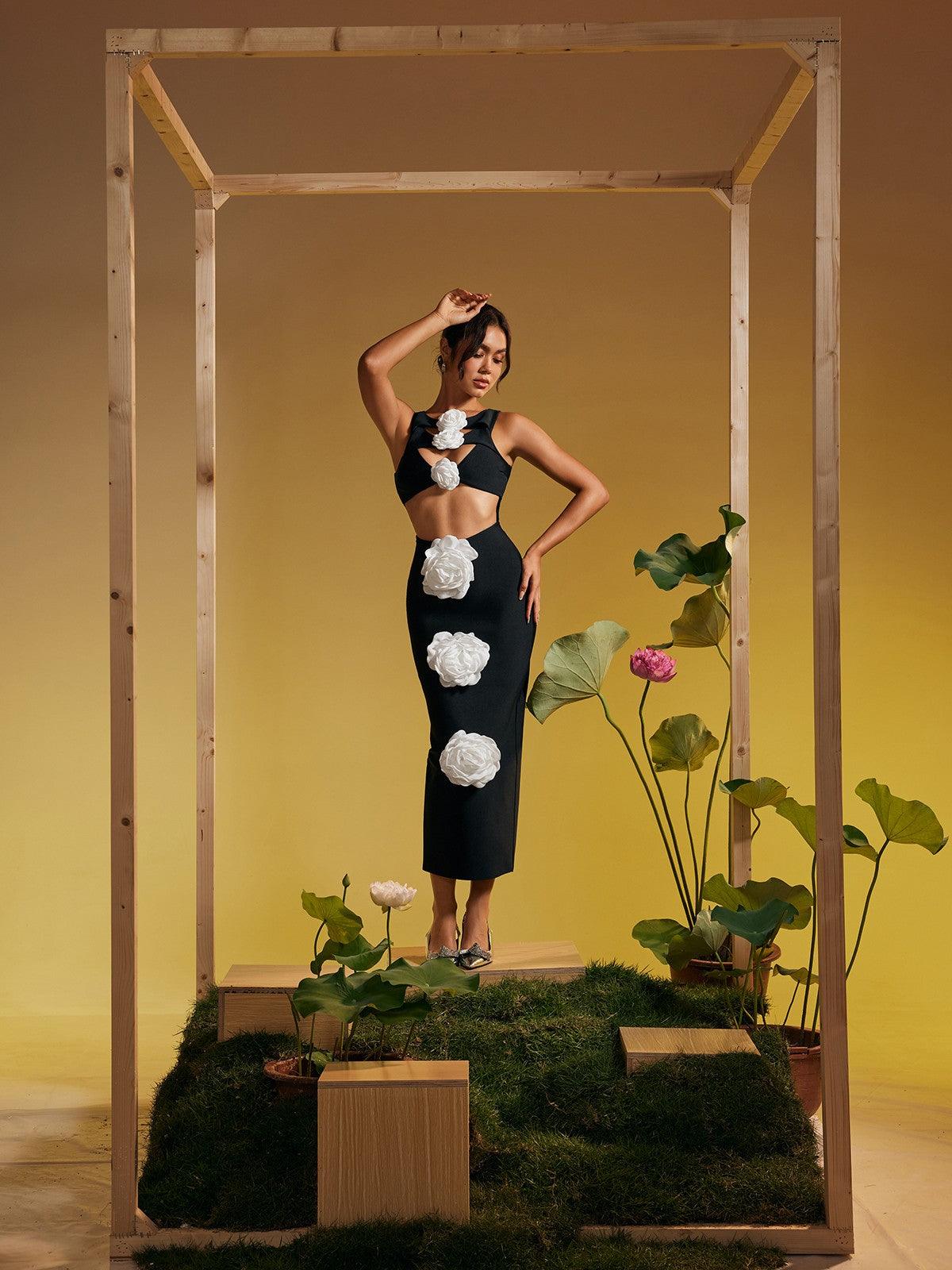 Model wearing the Atreyu sleeveless flower cutout midi dress at a cocktail party, exuding elegance.