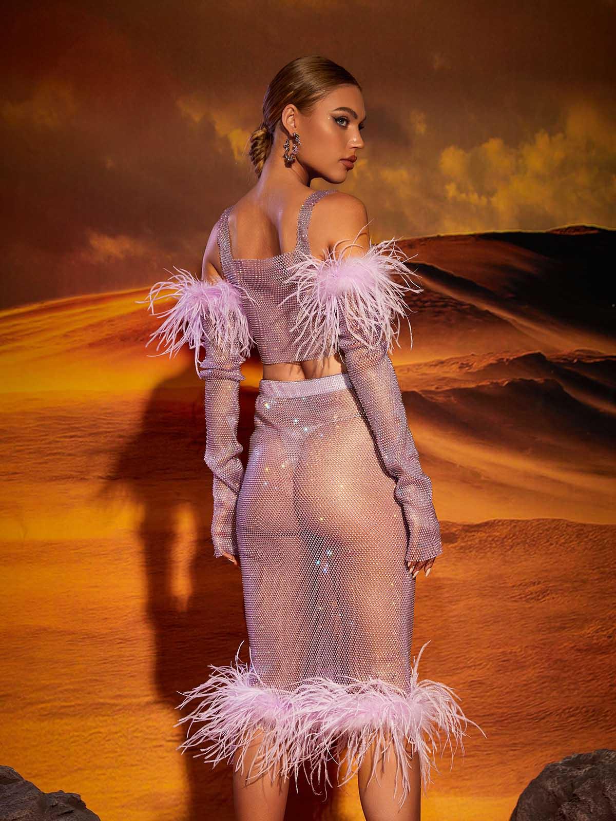 Model showcasing the Avery Mesh Diamond Feather Trimmed Skirt Set at a party, highlighting its eye-catching and luxurious design.
