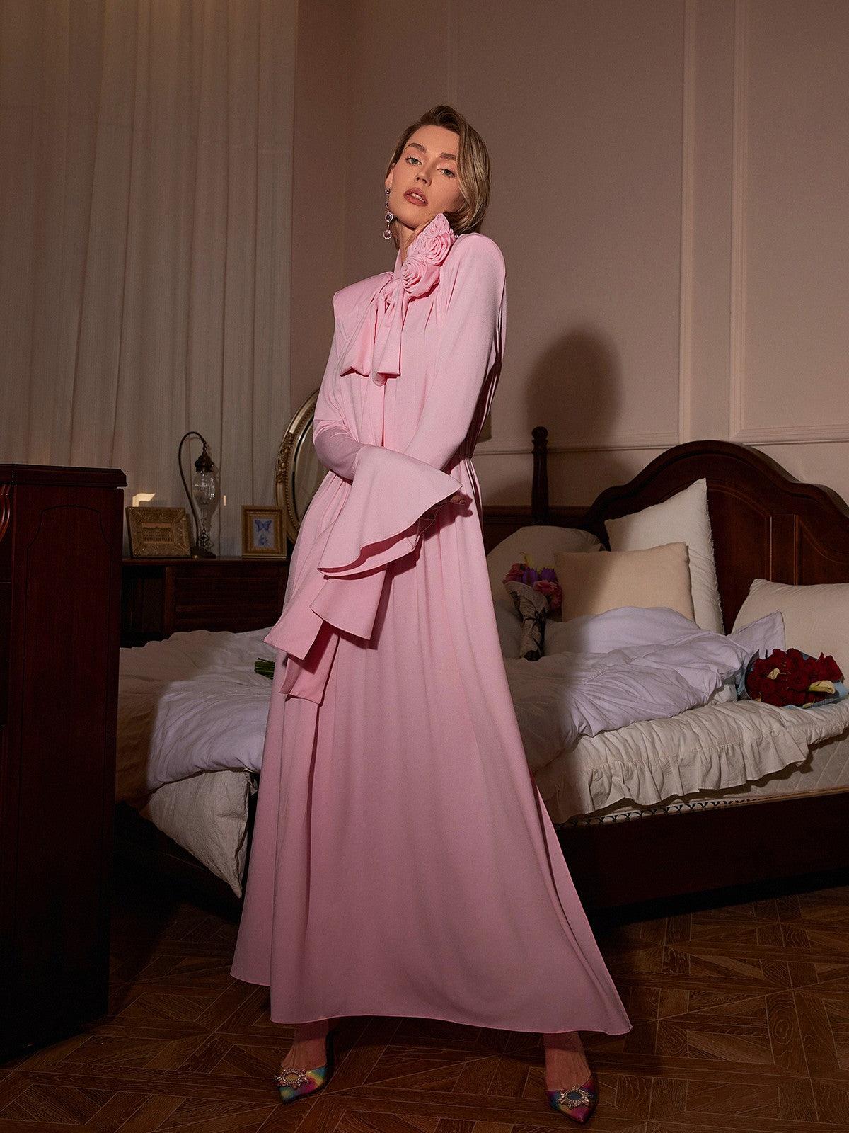 Model wearing the Benton Long Sleeve Flower Maxi Dress in Pink, demonstrating its elegant flow and stylish long sleeves in a beautiful setting.