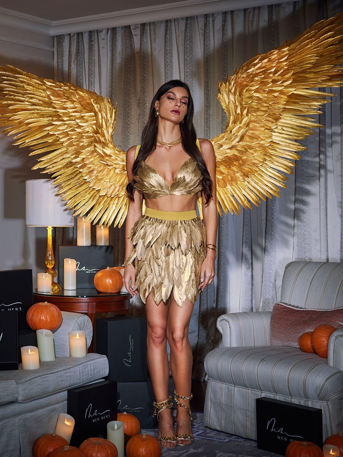 Close-up of the intricate feather details on the Brynhildr gold angel wings, showcasing luxury craftsmanship.