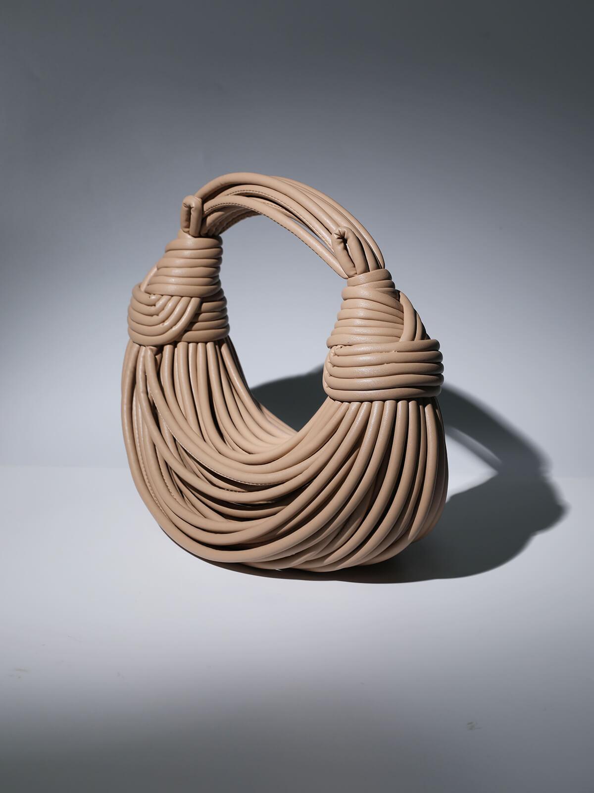 Camila Double Knot Tote Bag in Apricot being carried, perfect for a casual day out.