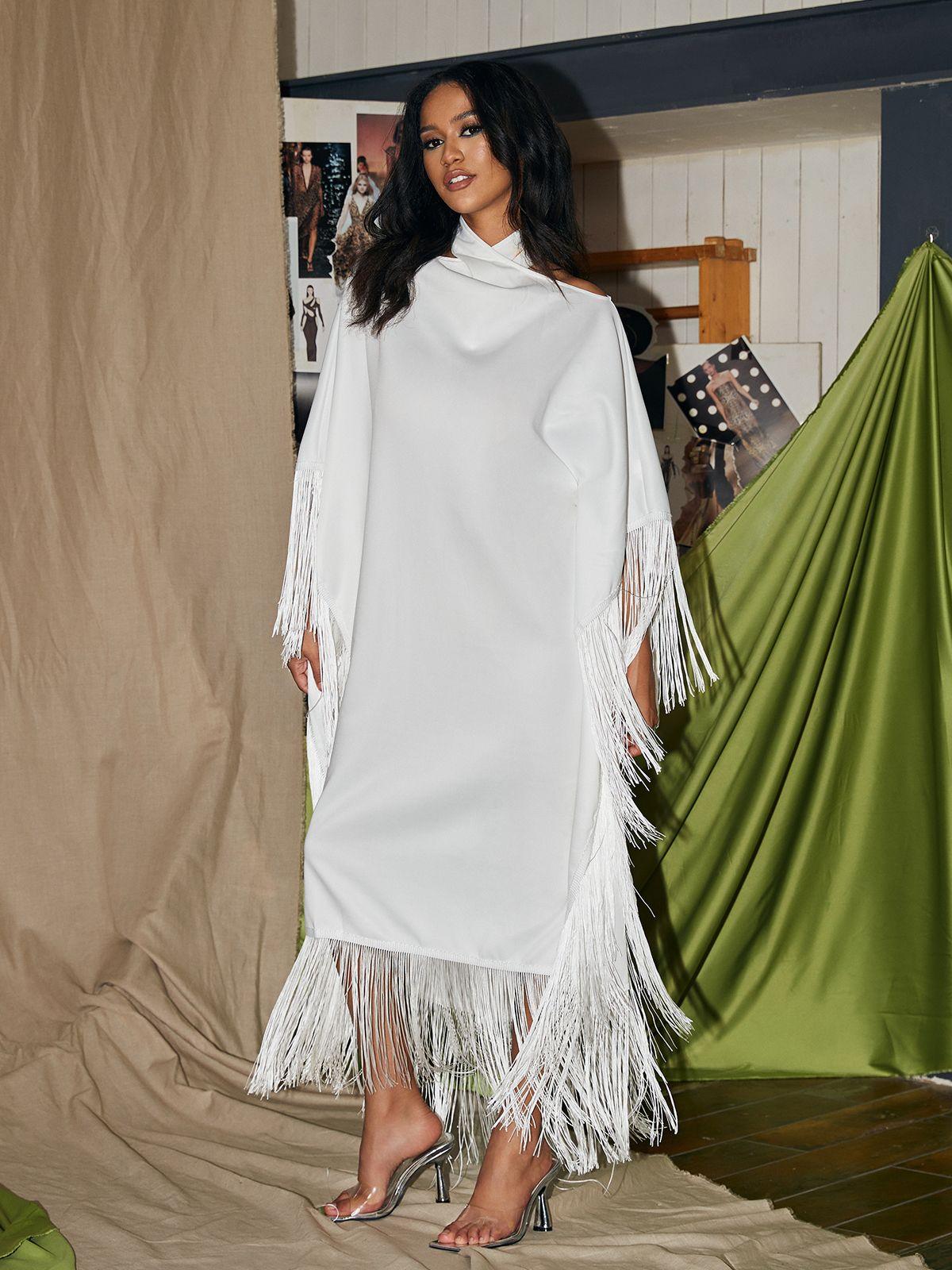 Ceridwen Cricross Fringe Kaftan Dress in white, showcasing a stylish halter neck and fringe details, ideal for cocktail parties.
