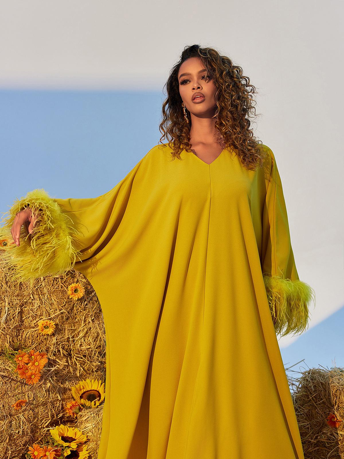Ceridwen V Neck Feather Trimmed Split Maxi Dress in yellow, showcasing elegant design and graceful silhouette.