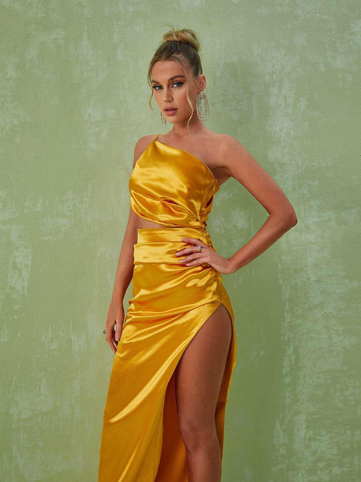 Elegant gold one shoulder cutout maxi dress with a ruched waist and split skirt, perfect for special occasions.