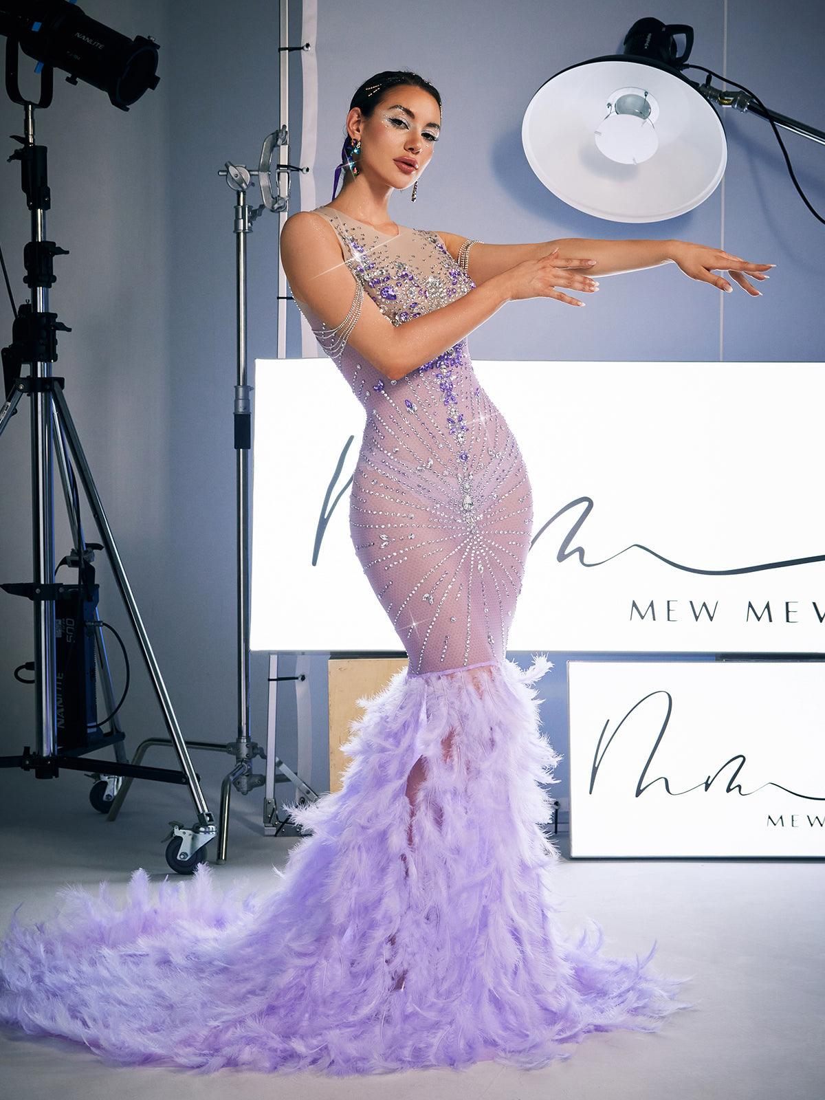 Model showcasing the Chaviv Rhinestone Feather Maxi Dress at a party, demonstrating its stunning feather and rhinestone features.