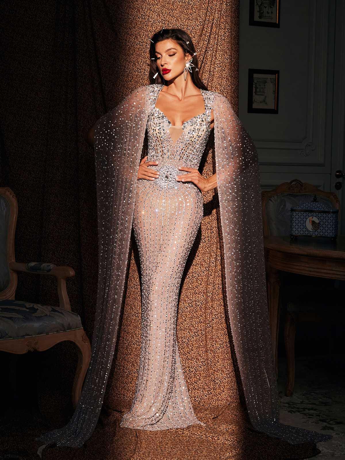 Chiara Rhinestone Cape Maxi Dress showcasing elegant rhinestone details and a flowy silhouette, perfect for special occasions.