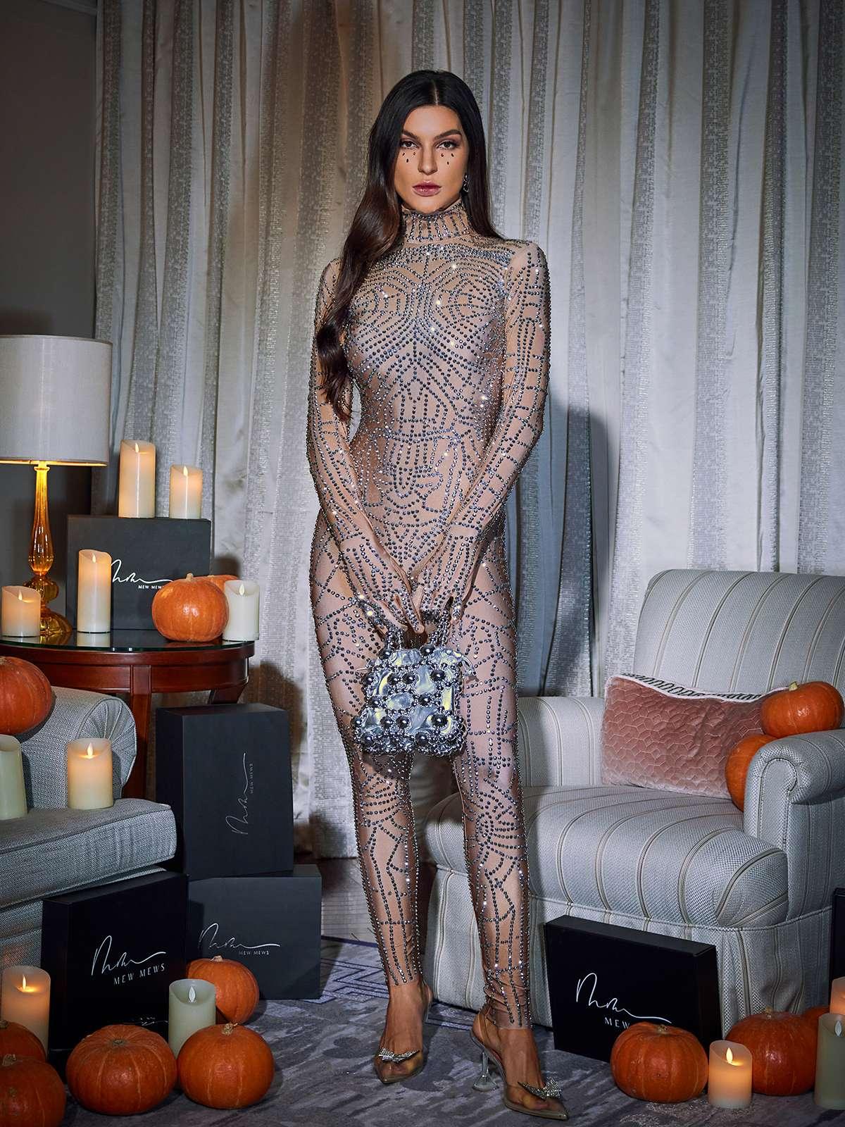 Stylish model wearing the Chimera Cobweb Rhinestone Jumpsuit at a festival, showcasing its elegant design and comfortable fit.