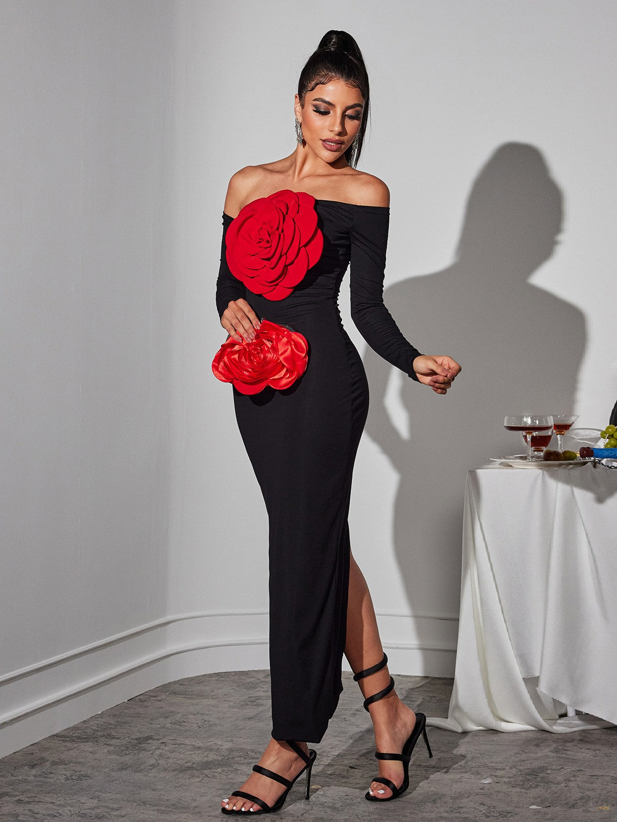 Detail of the floral embellishments on the Claus Off Shoulder Red Flower Maxi Dress, showcasing its elegance.