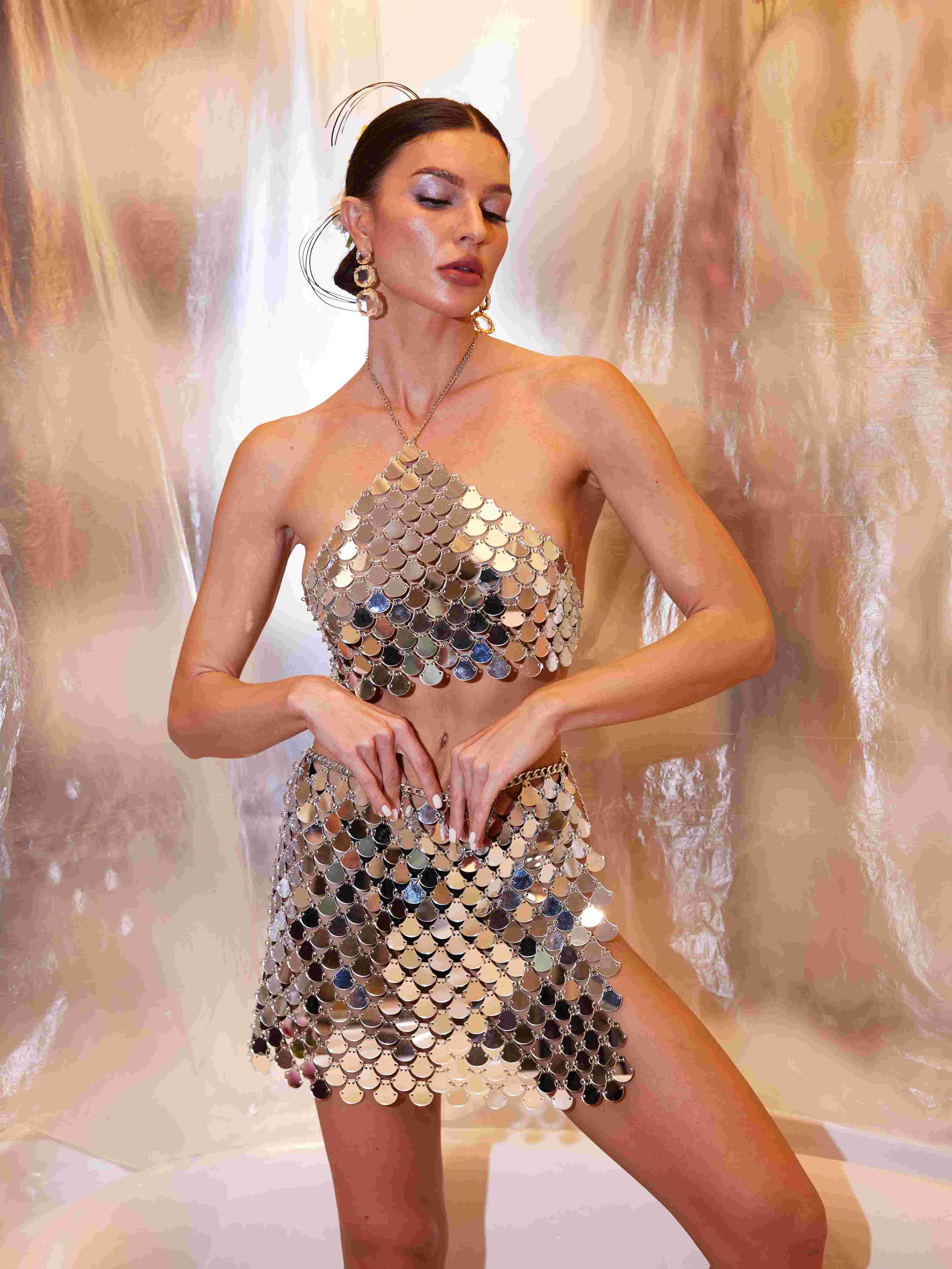 Model wearing the Colton Halterneck Chainmail Skirt Set at a festival, embodying luxury and bold fashion.