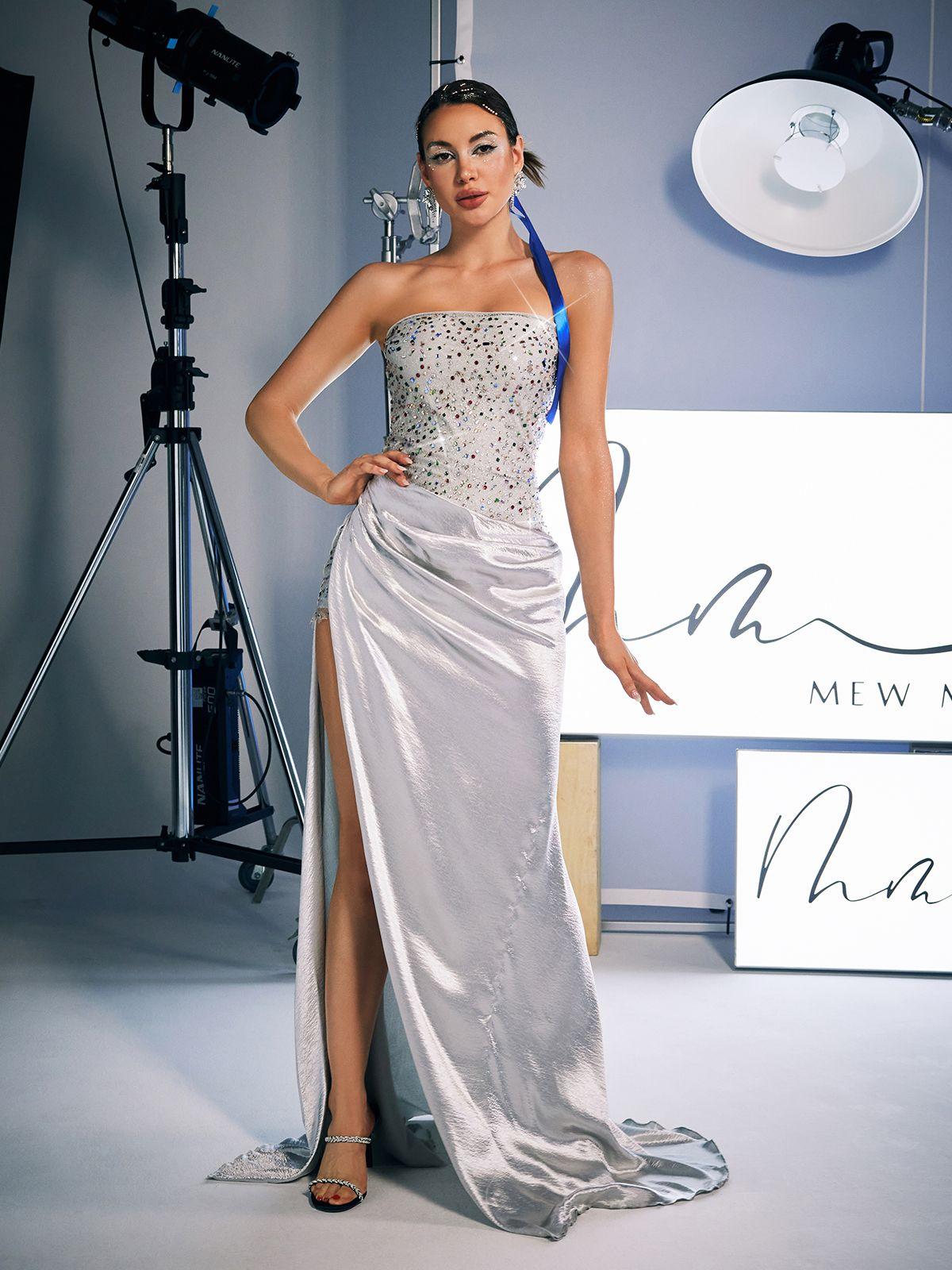 Model showcasing the Corey Rhinestone Satin Maxi Dress, highlighting its flowing satin fabric and stunning strapless fit.