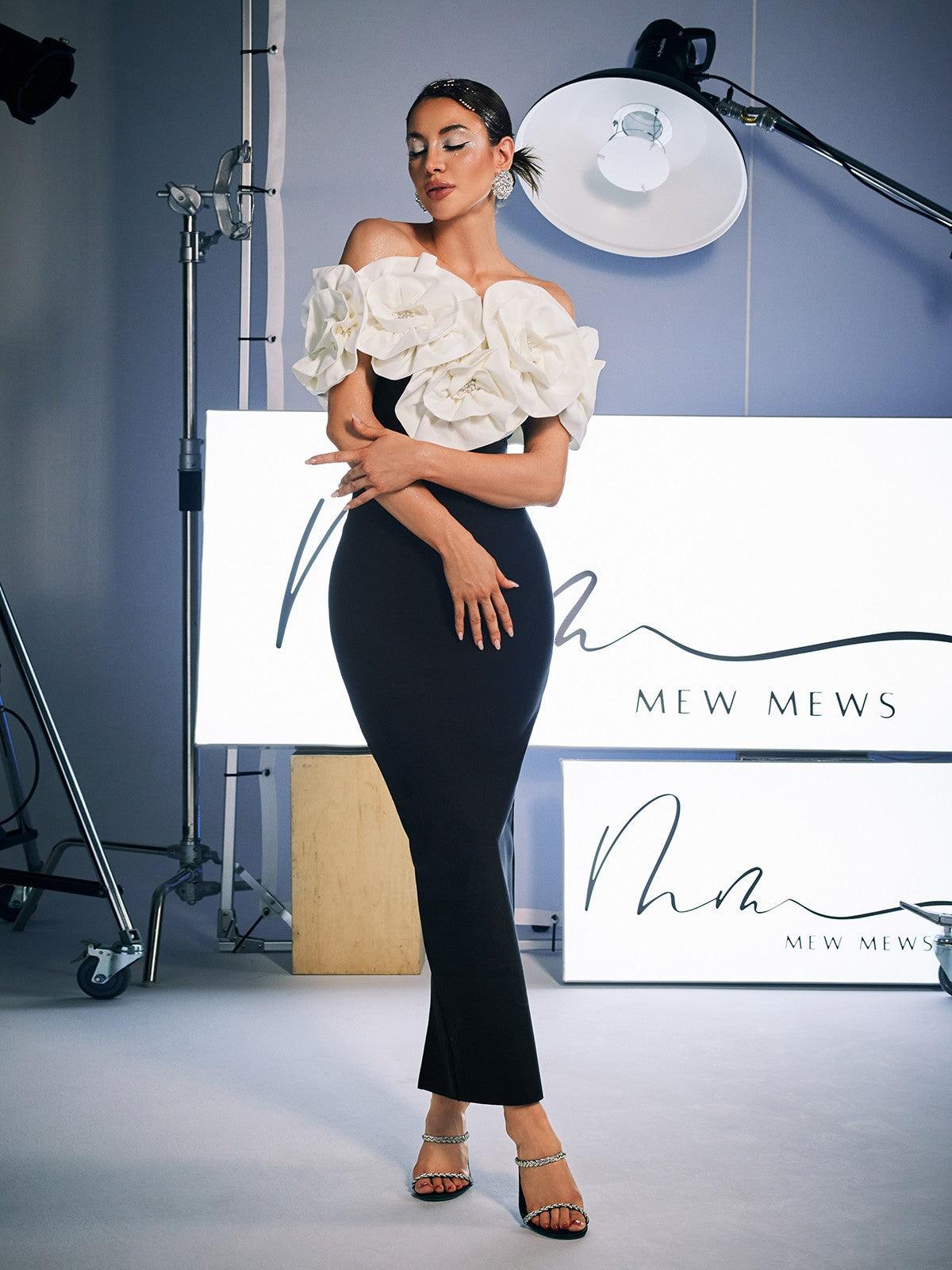 Elegant Creed Off Shoulder Flower Bandage Dress in black, featuring floral detailing and a high stretch fit.