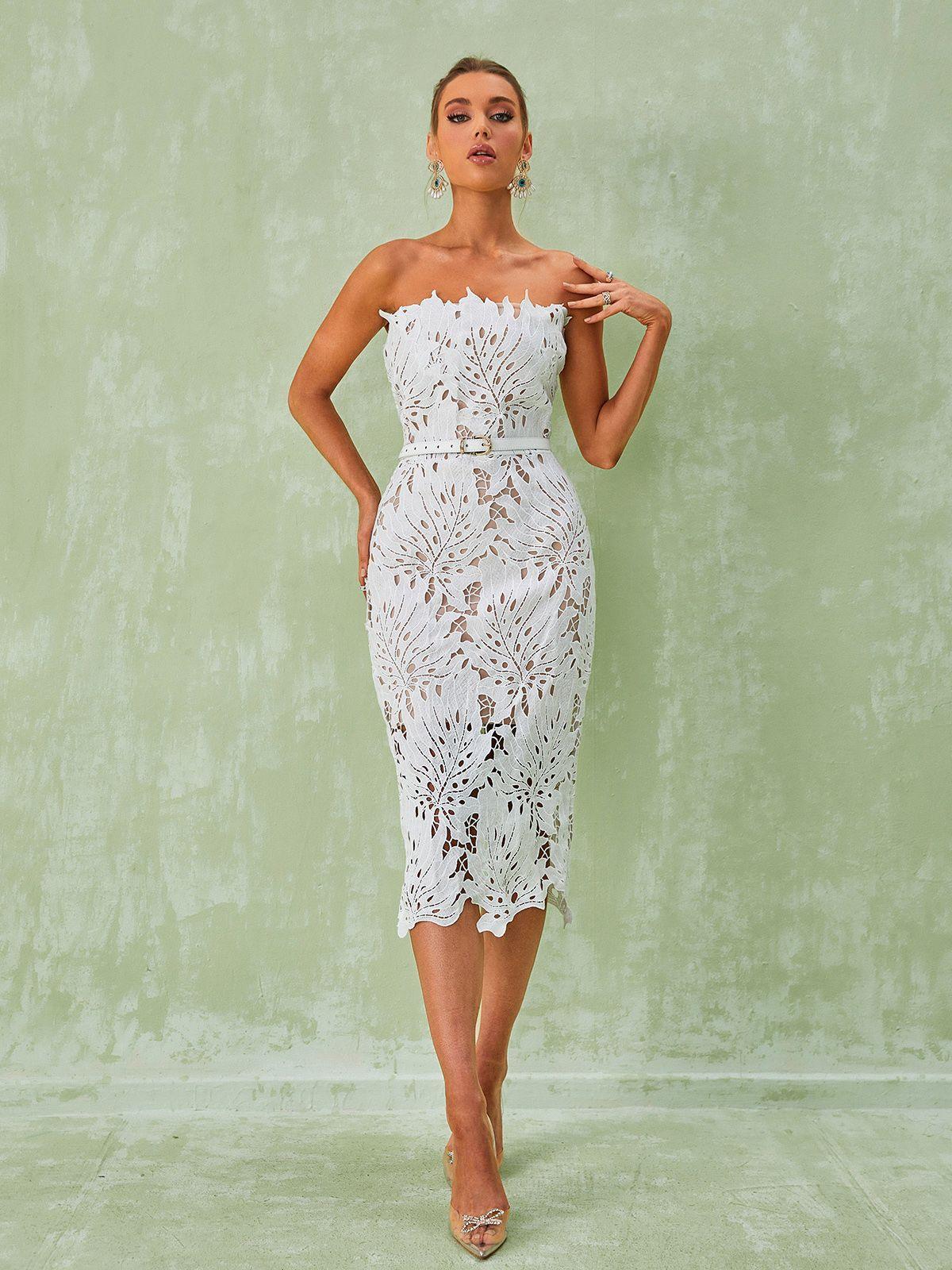 Model wearing the Despina White Lace Midi Dress at a cocktail event, showcasing its flattering fit and sophisticated style.