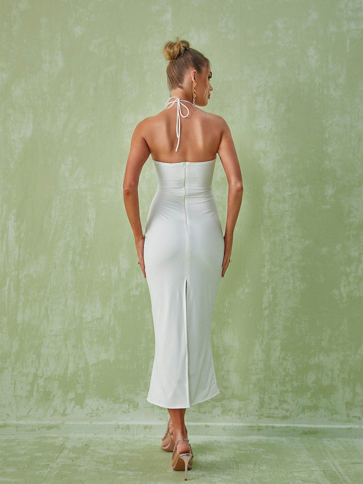 The Dorcas Halterneck Cutout Midi Dress in white, featuring elegant cutouts and a stylish design perfect for formal wear.