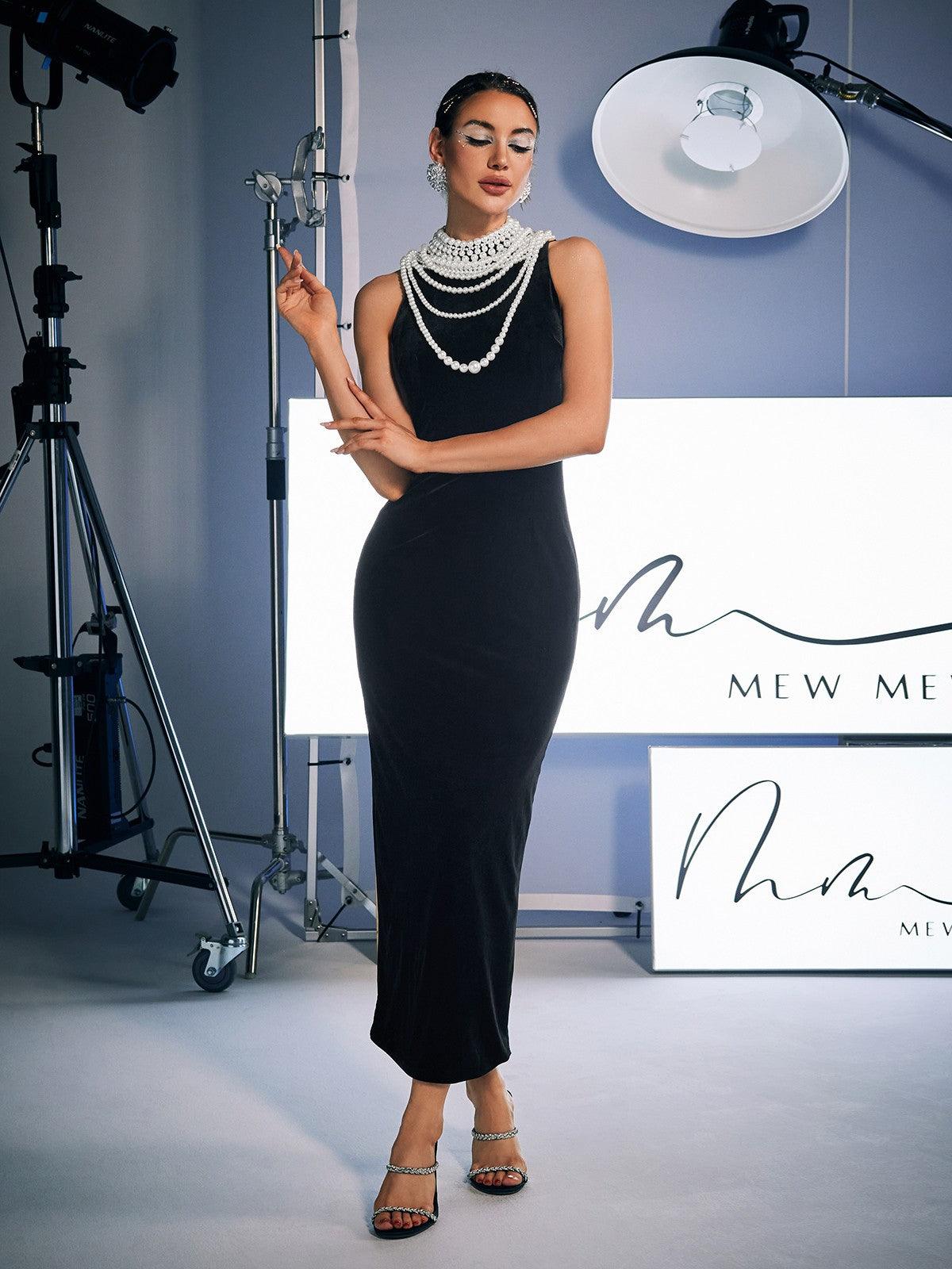 Model showcasing the elegant split design of the Dustin High Neck Pearl Embellished Maxi Dress, perfect for confident styling.