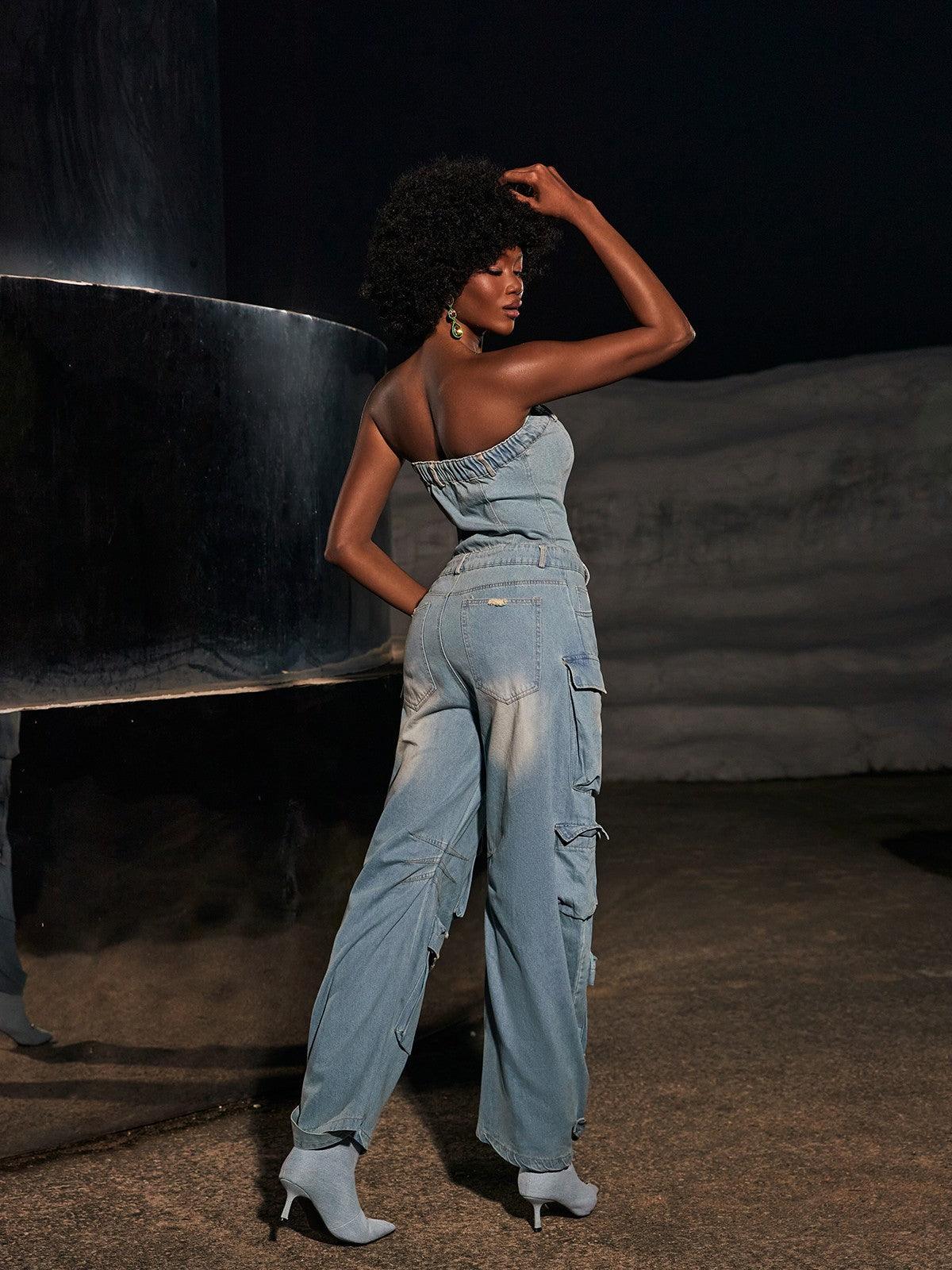 Eden Strapless Pocket Denim Jumpsuit on display in a stylish outdoor setting.
