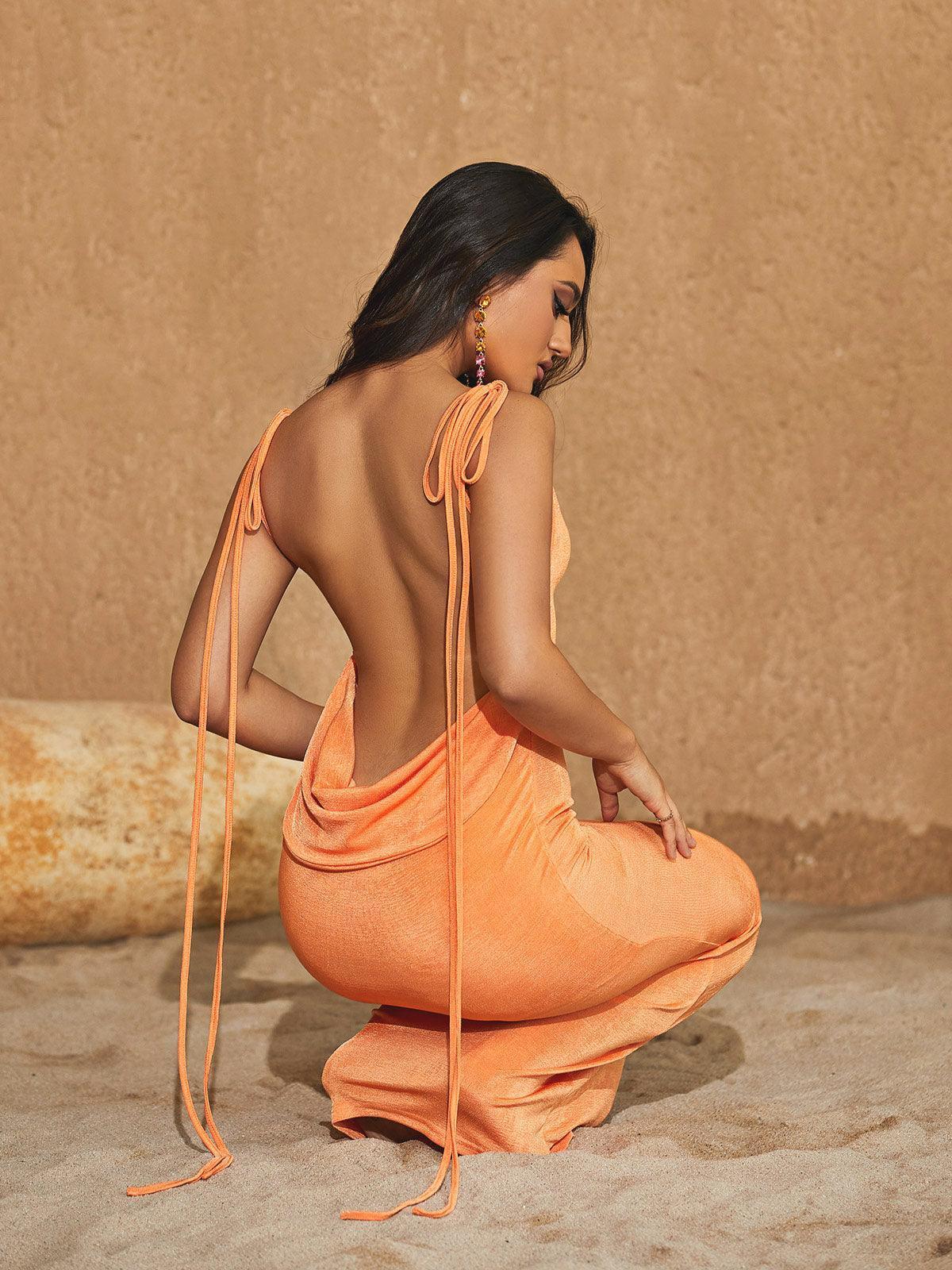 Elegant orange backless maxi dress with drape detail, ideal for special occasions.