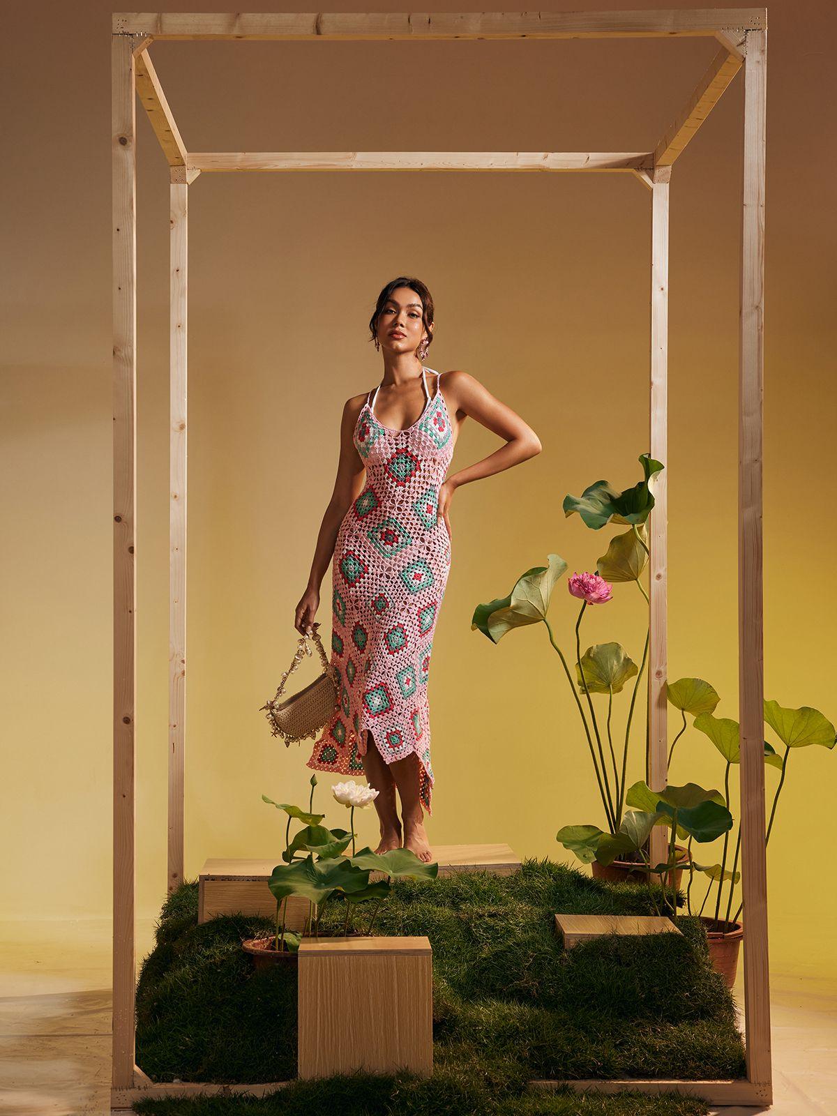 Eliora Open Back Hollow Knitted Midi Dress in pink with elegant design and hollow details, perfect for stylish vacations.