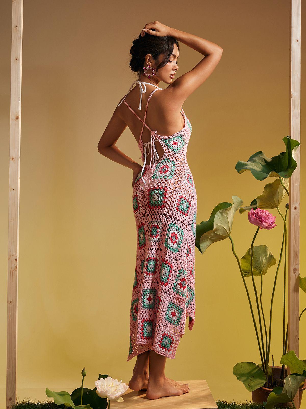 Eliora Open Back Hollow Knitted Midi Dress in pink with elegant design and hollow details, perfect for stylish vacations.