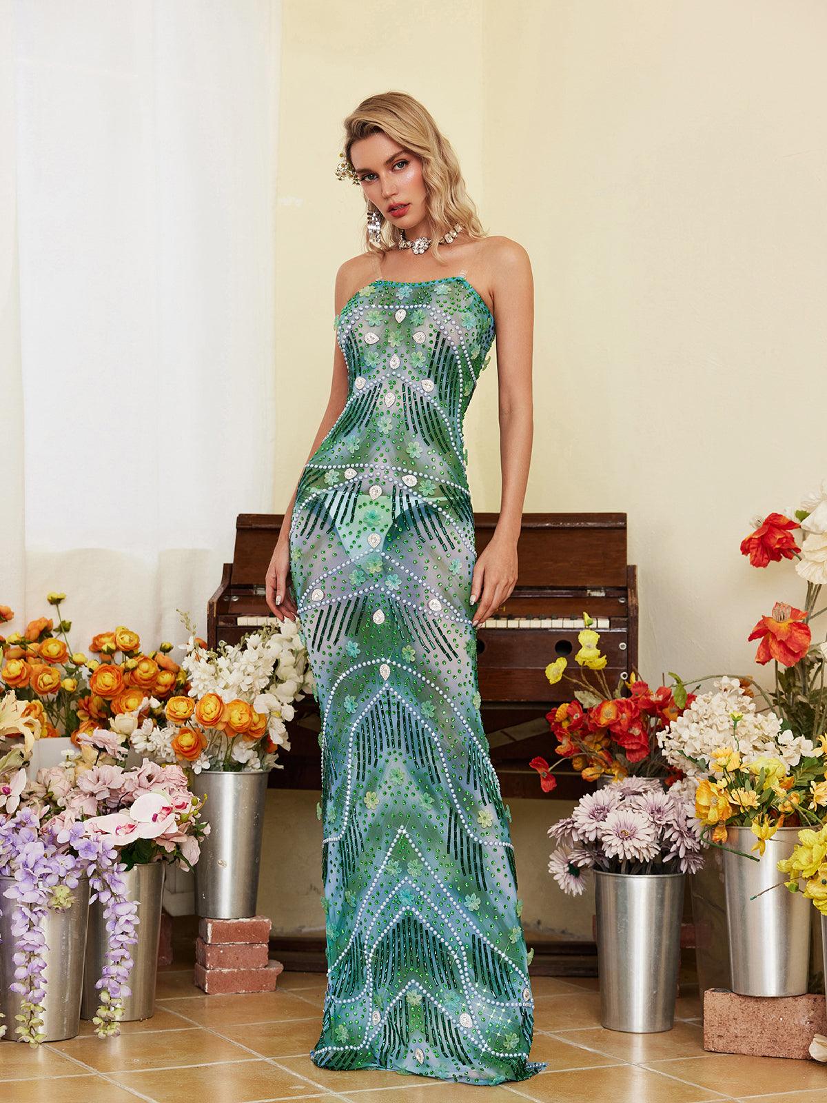 Model wearing the Ennis Strapless Flower Embellished Maxi Dress at a party, showcasing its flowy silhouette and elegance.