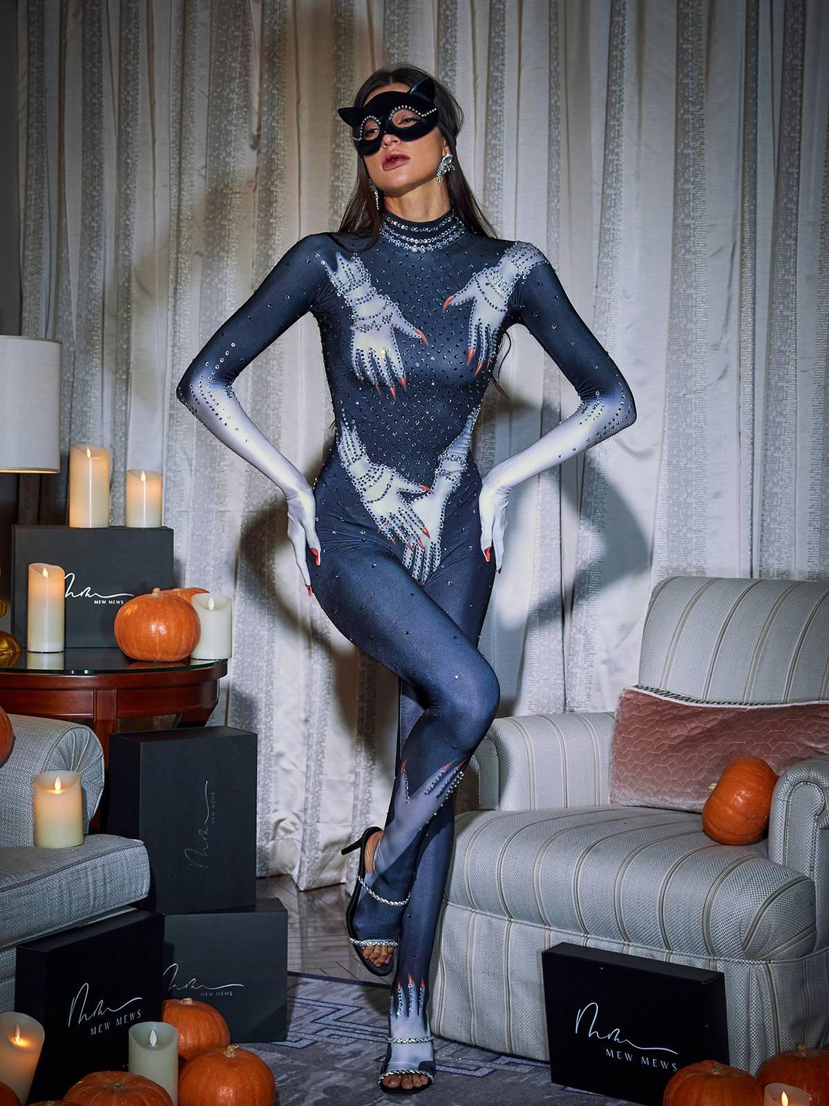 Full view of the black jumpsuit showcasing the Esau Hands print and luxurious materials.