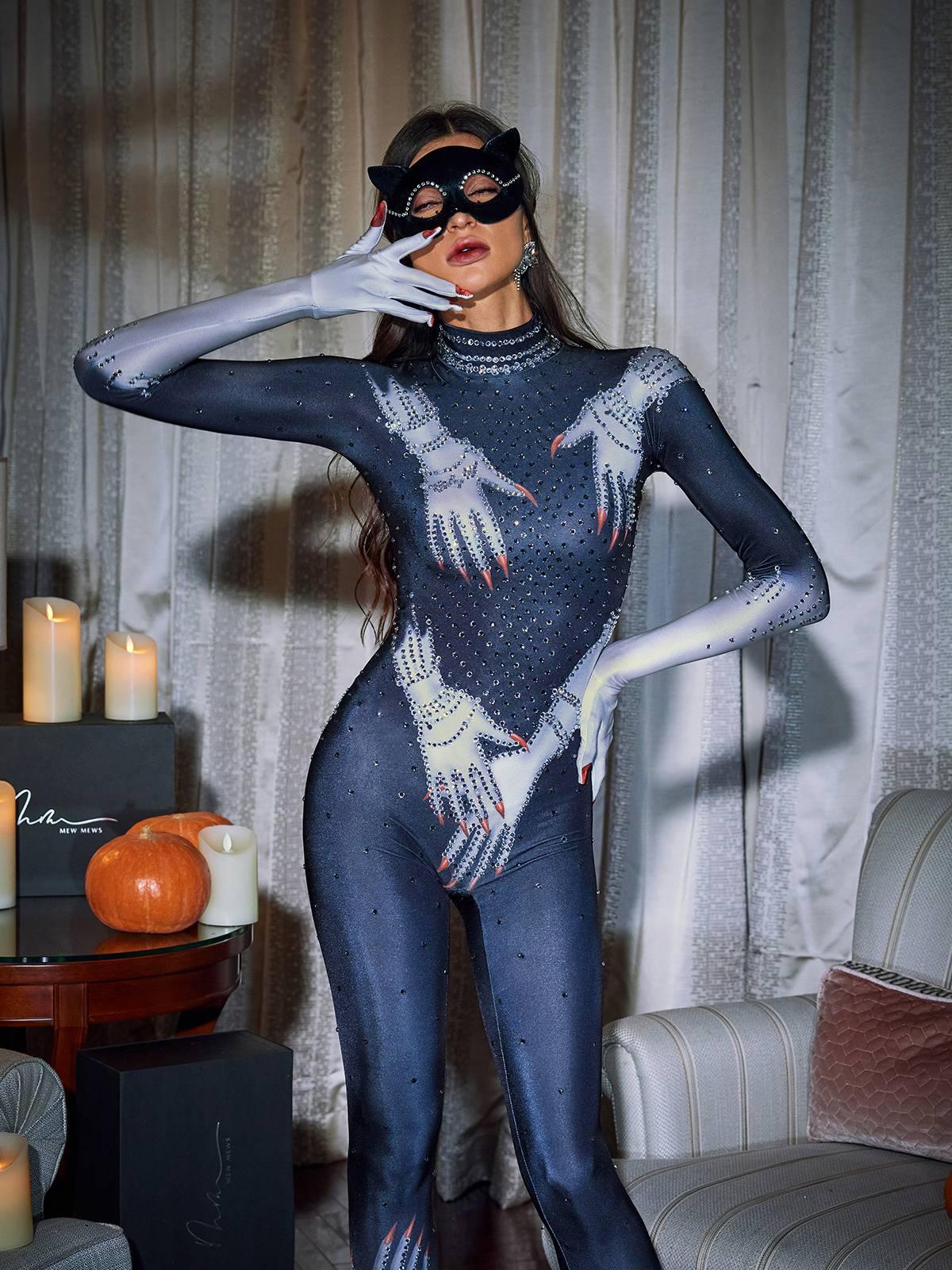 Black jumpsuit featuring Esau Hands print and dazzling rhinestone gloves for a stylish evening wear statement.