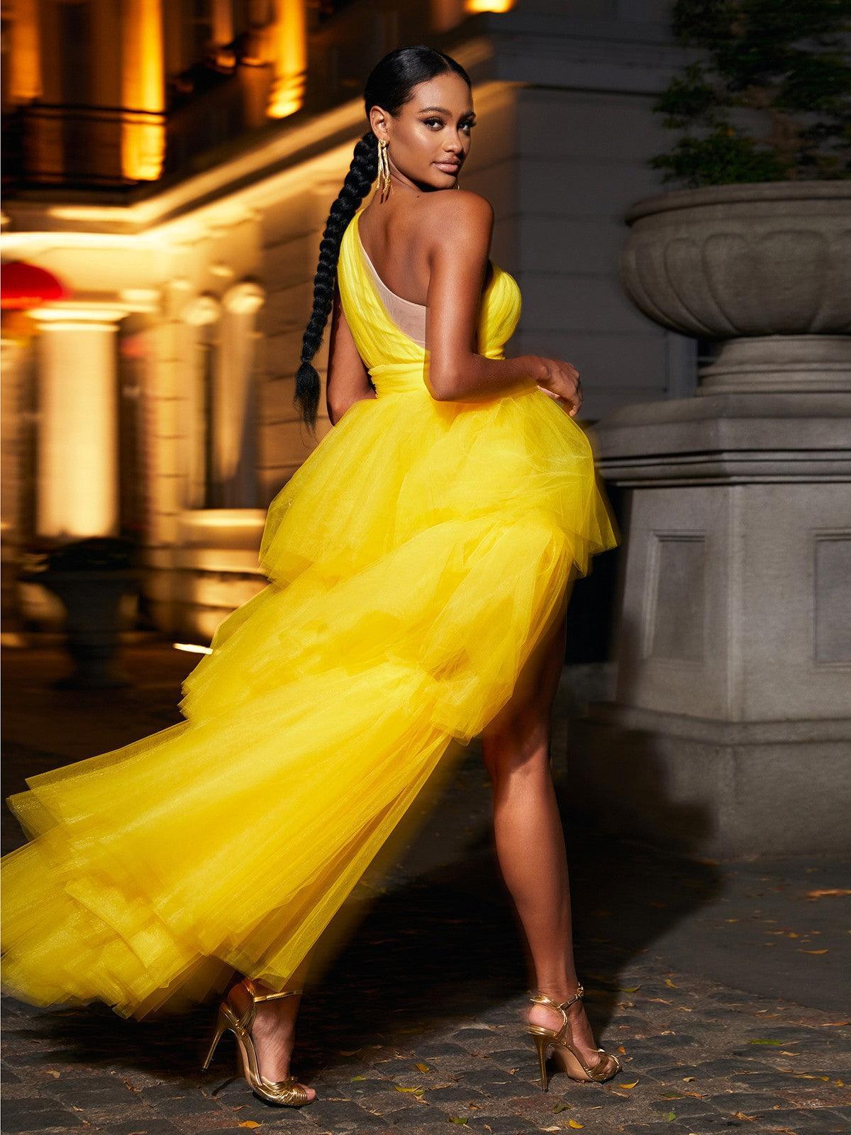 Model showcasing the Essie One Shoulder Tulle Maxi Dress in yellow at a formal event, exuding elegance and grace.