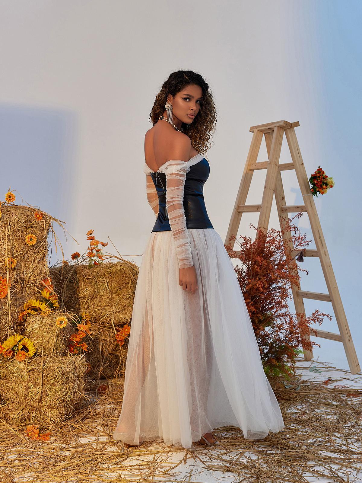 Gasira Tulle Maxi Dress in white featuring airy layers, off-shoulder design, and elegant back zipper for special occasions.