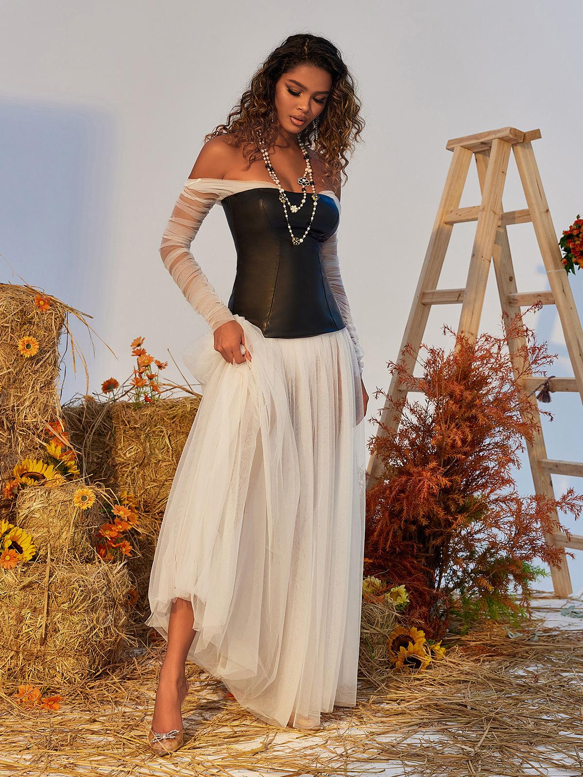 Detailed view of the Gasira Tulle Maxi Dress showcasing its luxurious tulle layers and elegant off-shoulder style.