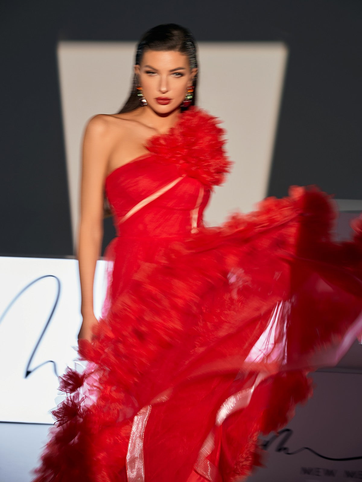 Close-up of the Ghslaine One Shoulder Tulle Midi Dress showing the exquisite tulle texture and elegant silhouette.