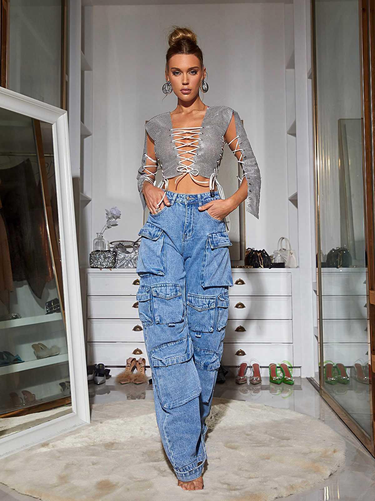 Flat lay of Giulia Denim Pants in Blue highlighting the unique features like multiple pockets and hand wash care instructions.