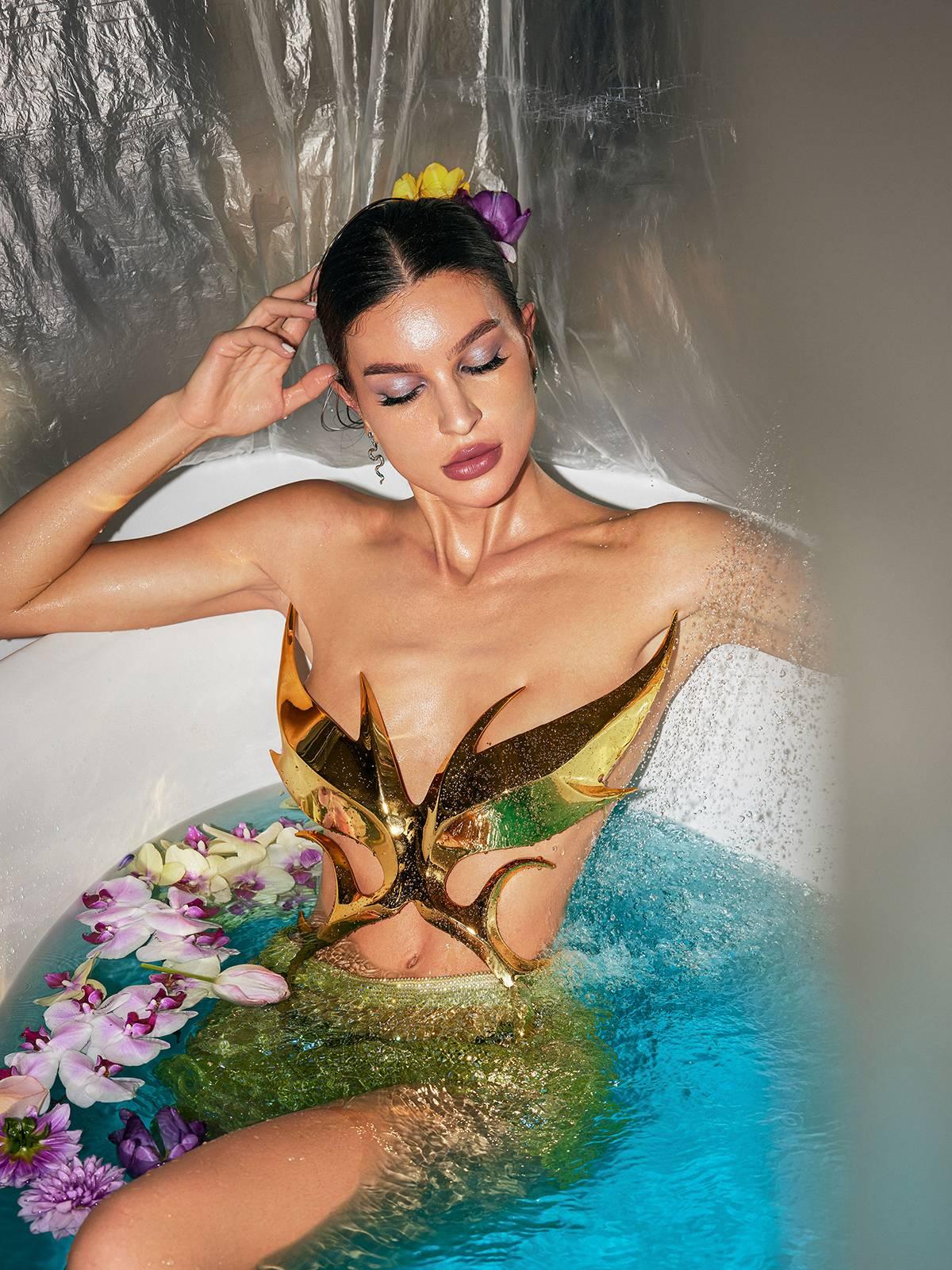 Ilya Butterfly Glossy Armor Top in Gold featuring a unique butterfly design and glossy finish, ideal for stylish outings.