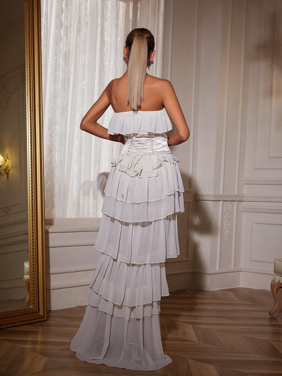 Elegant white strapless ruched mesh maxi dress.  Perfect for parties and weddings. Features a flattering ruched bodice and flowing maxi skirt.