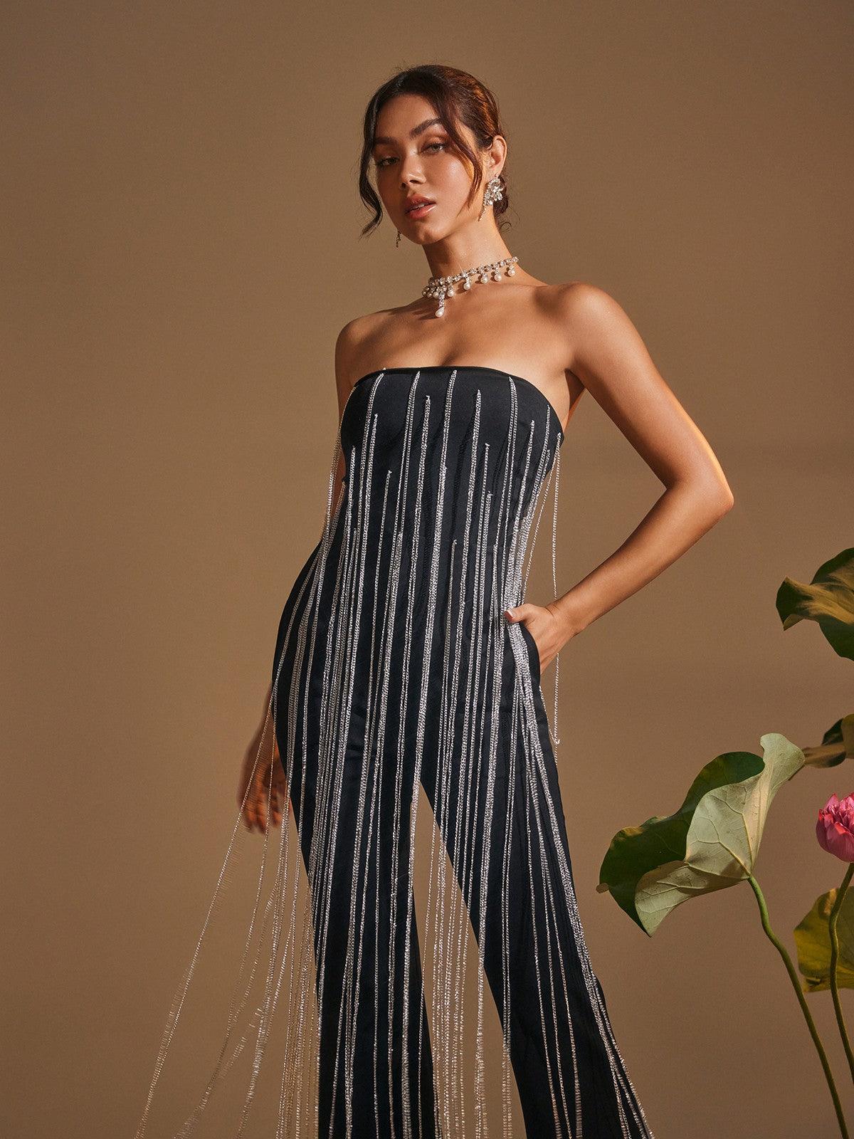 Dazzle in the Kaveri Strapless Crystal Chain Fringe Jumpsuit.  A stunning black jumpsuit with shimmering crystal fringe detail, ideal for evening events and special occasions.