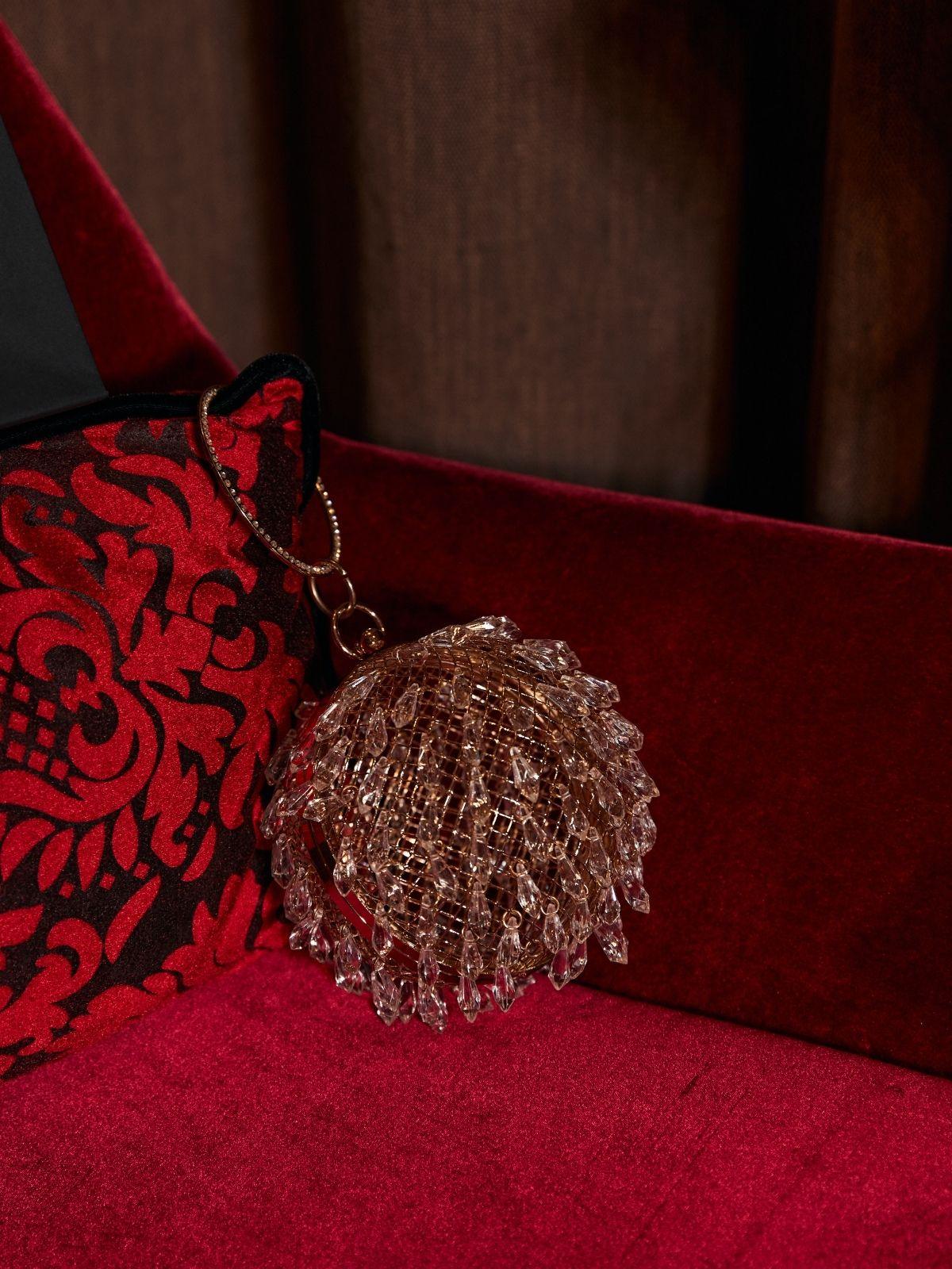 Stylish Kethel Drip Clear Ball Clutch.  A modern, transparent acrylic handbag with a ball clasp, perfect for evening events and special occasions.  Available in Gold and White.