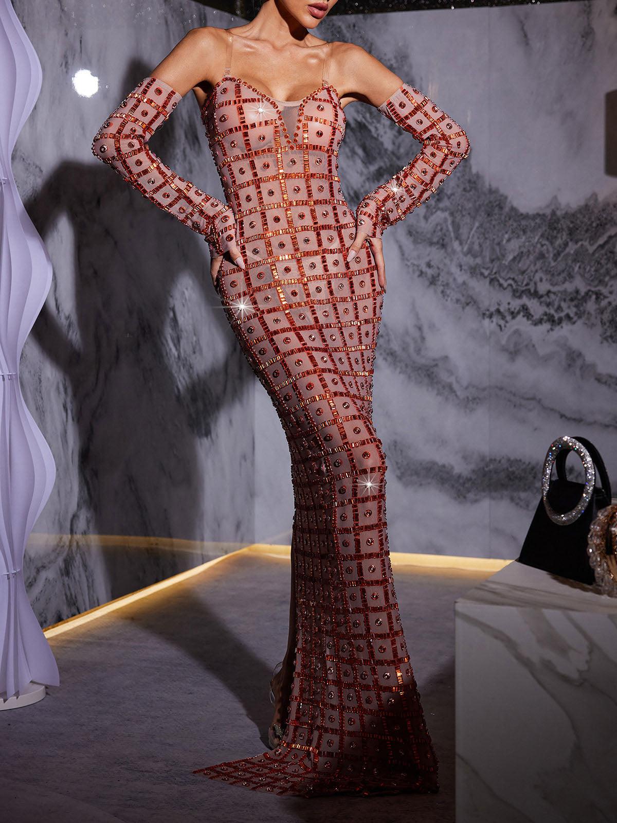 Stunning model in a nude Kieran Rhinestone Mesh Maxi Dress.  The strapless, sparkly maxi dress features intricate rhinestone detailing and a flowing mesh skirt. Perfect for prom or an elegant evening event.