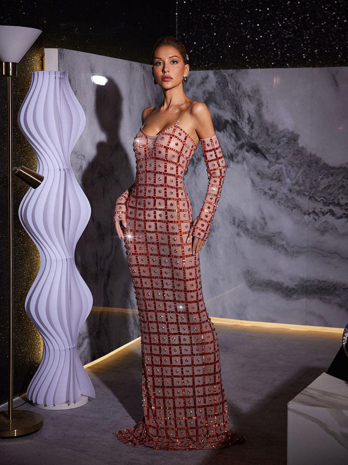 Stunning model in a nude Kieran Rhinestone Mesh Maxi Dress.  The strapless, sparkly maxi dress features intricate rhinestone detailing and a flowing mesh skirt. Perfect for prom or an elegant evening event.