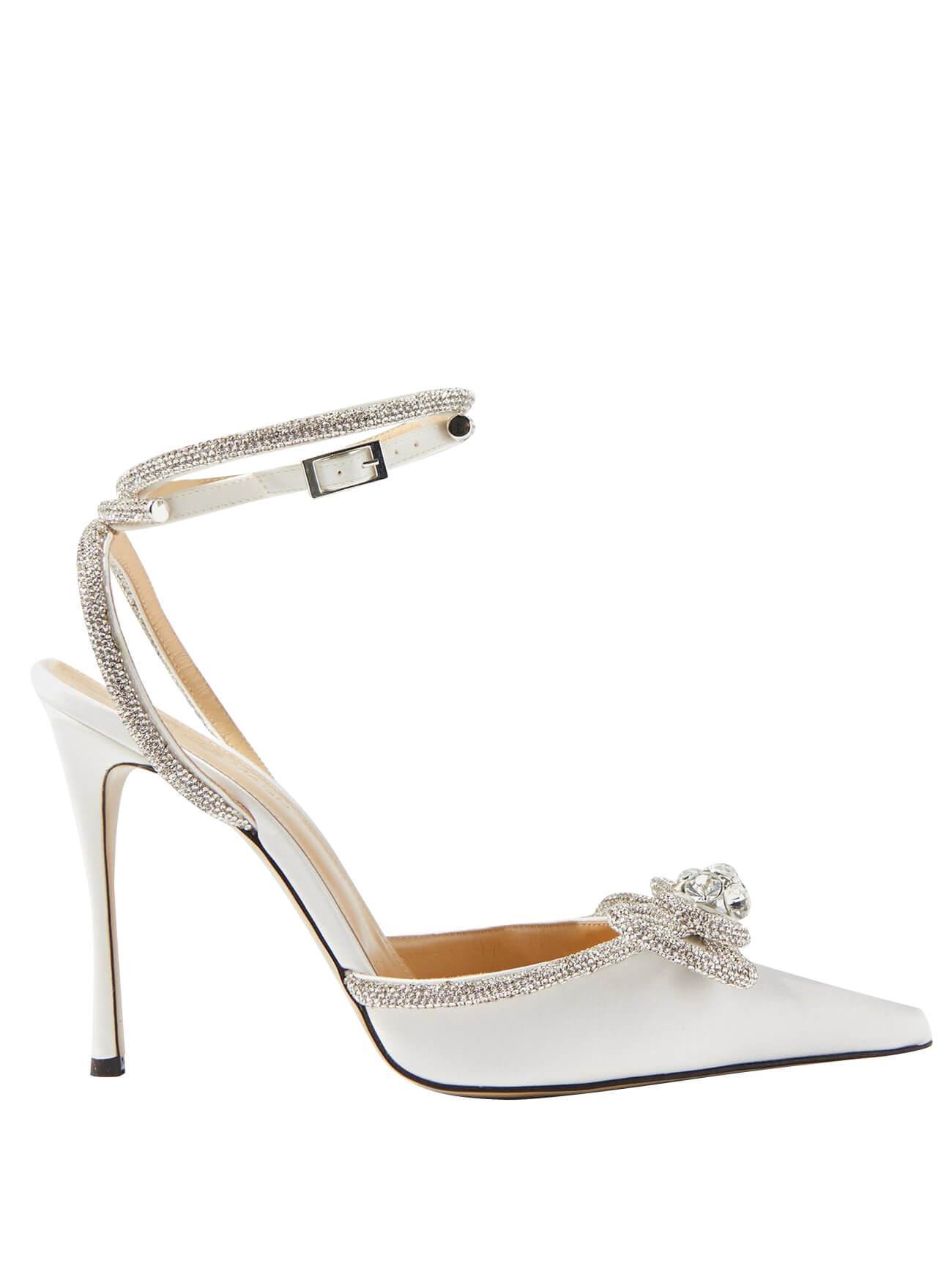 Elegant white satin high heels with a delicate crystal bow and ankle strap.  Pointed toe, 11cm heel. Custom-made luxury bridal shoes for special events.
