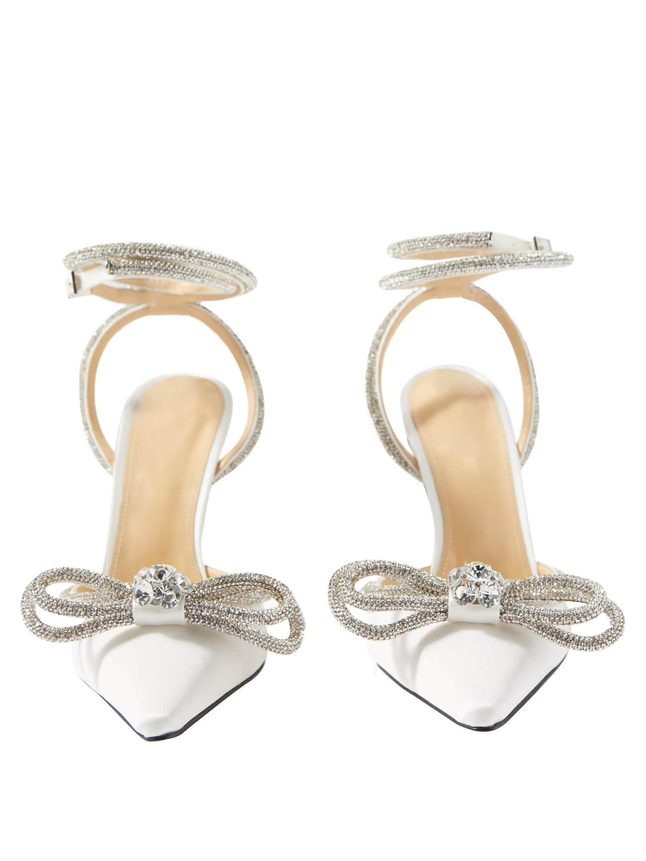 Elegant white satin high heels with a delicate crystal bow and ankle strap.  Pointed toe, 11cm heel. Custom-made luxury bridal shoes for special events.